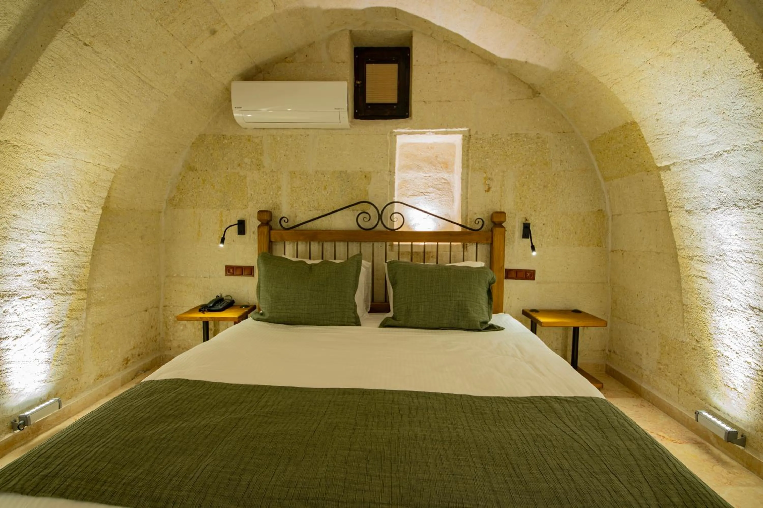 Bed in Ares Cave Suites