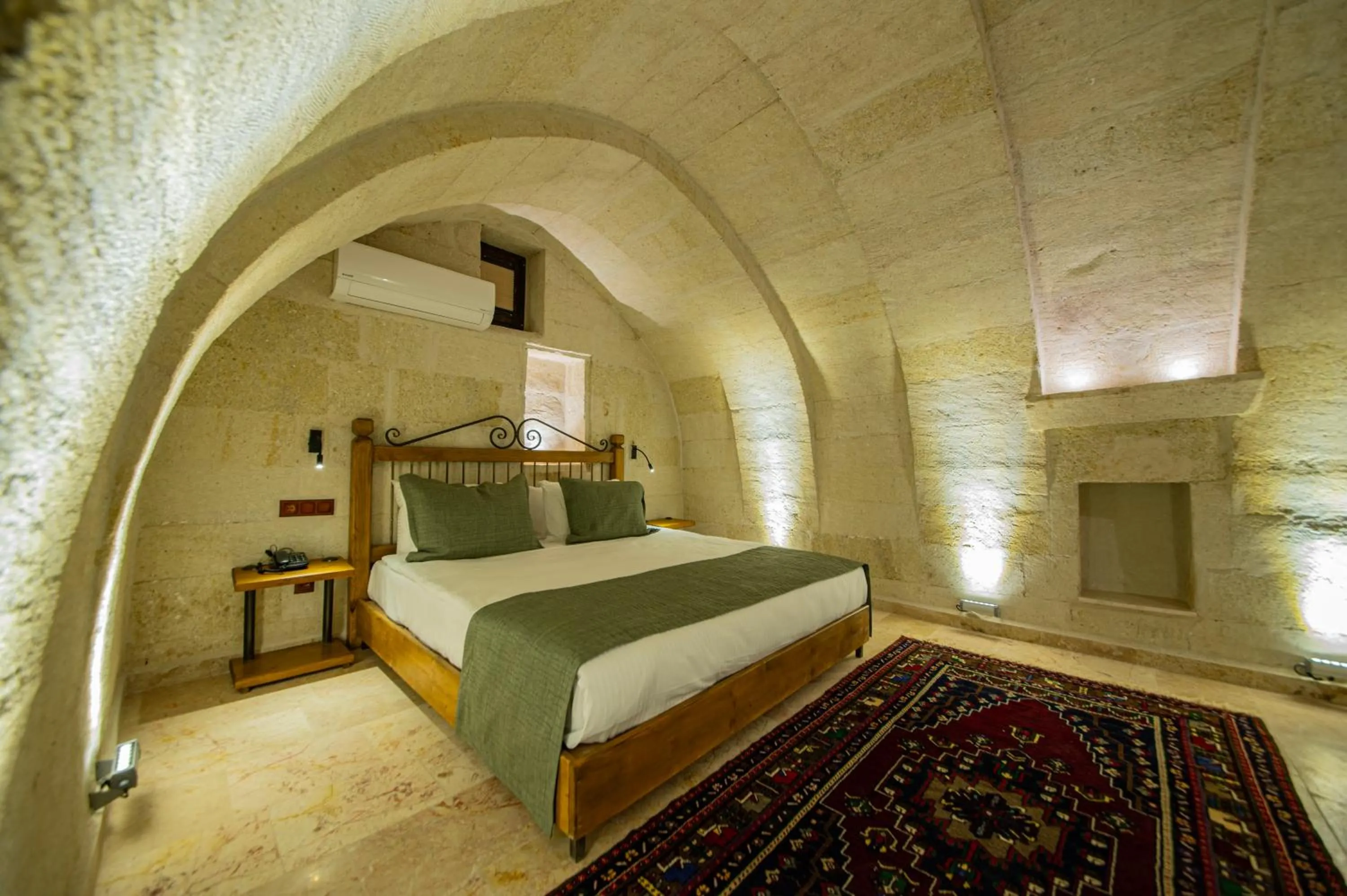 Bed in Ares Cave Suites