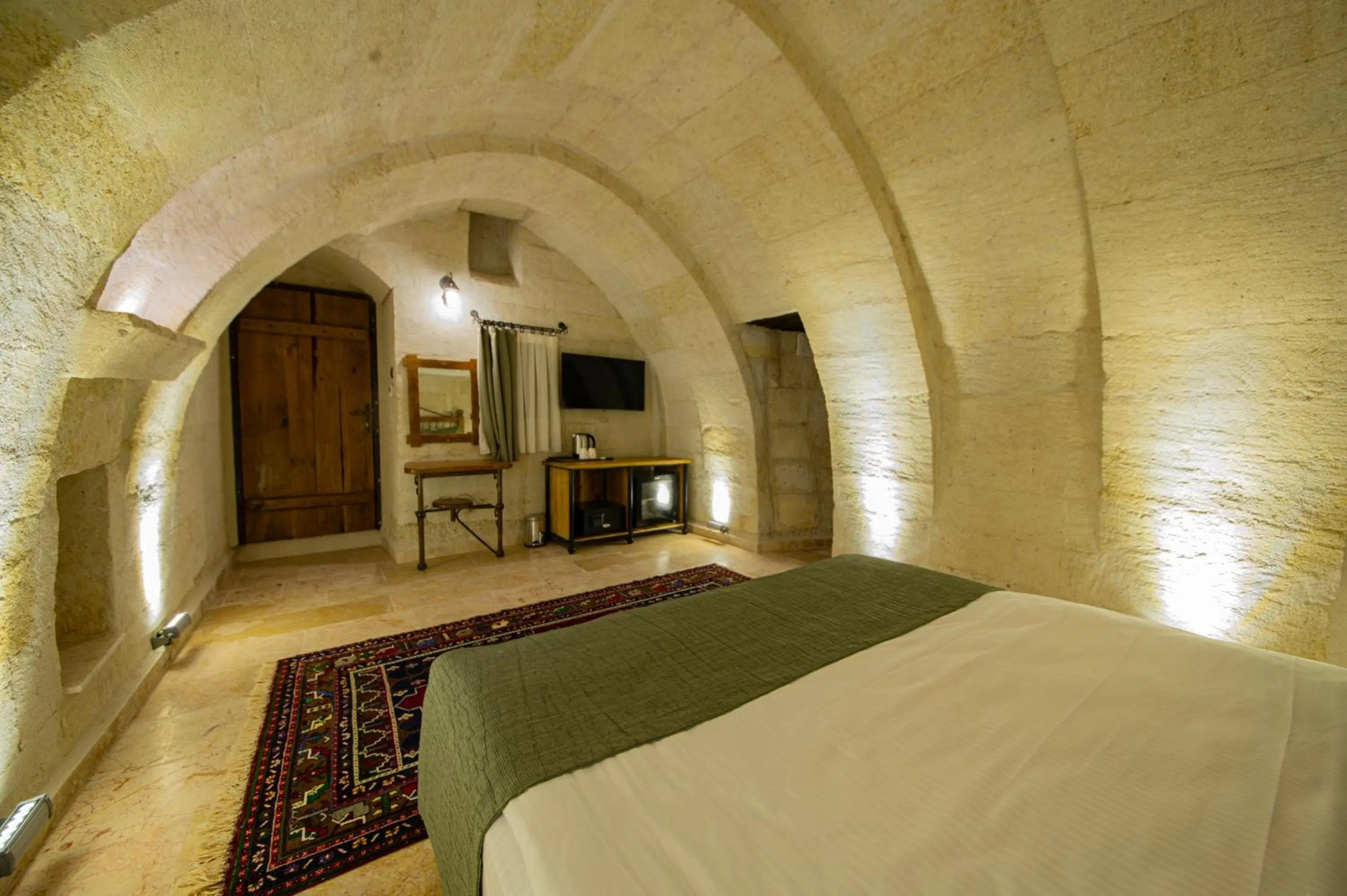 Bed in Ares Cave Suites