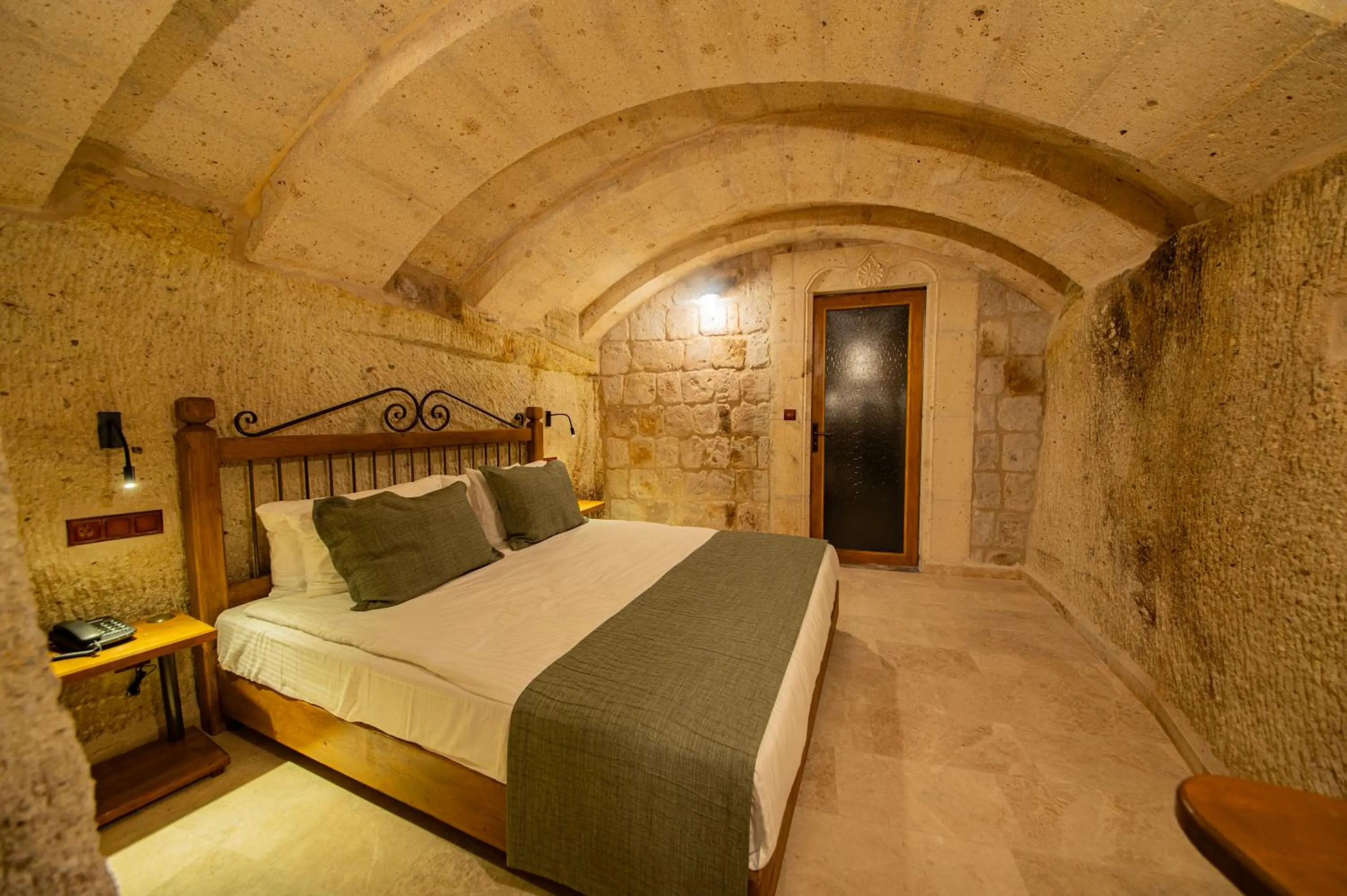 Bed in Ares Cave Suites