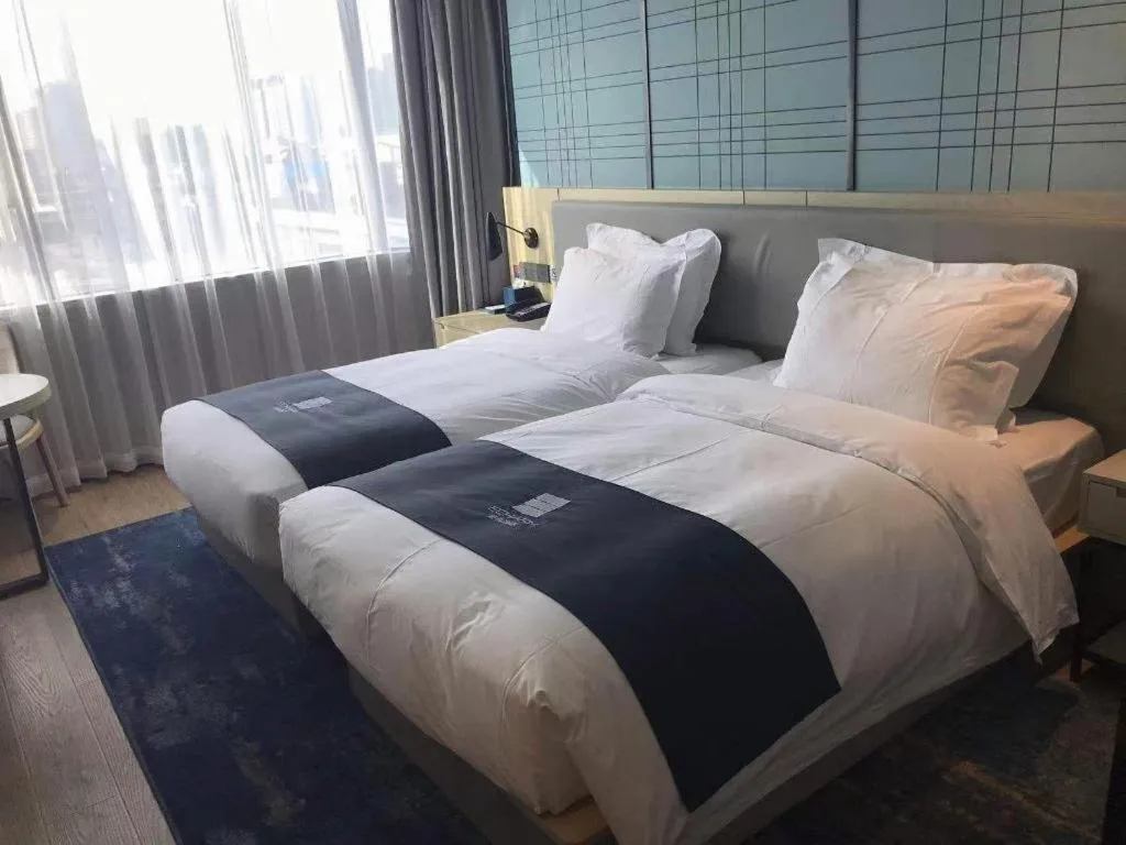Bed in Echarm Hotel Shenzhen International Exhibition Center Fuyong