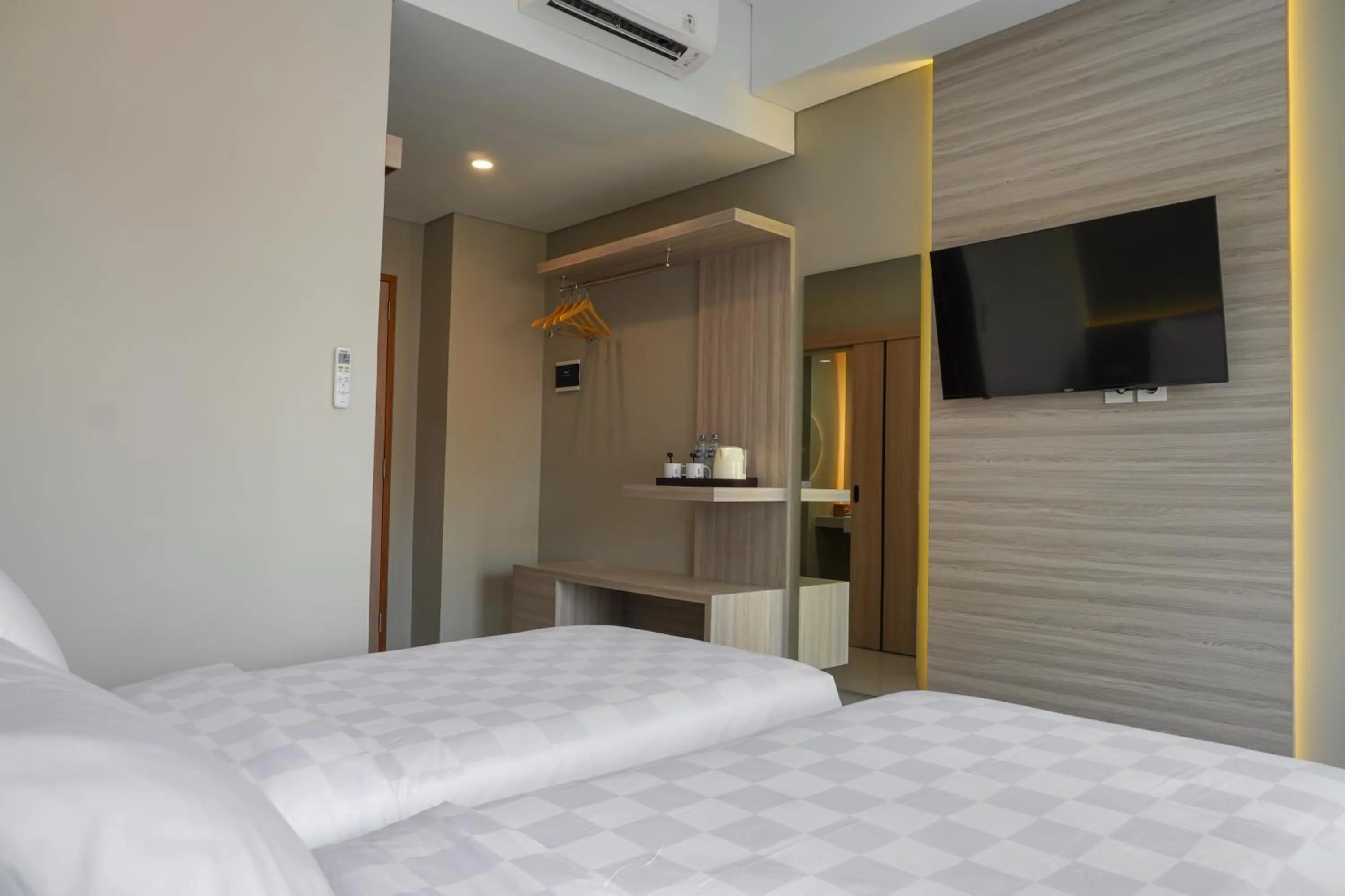 Bed in Sajiwa Inn and Suite Hotel