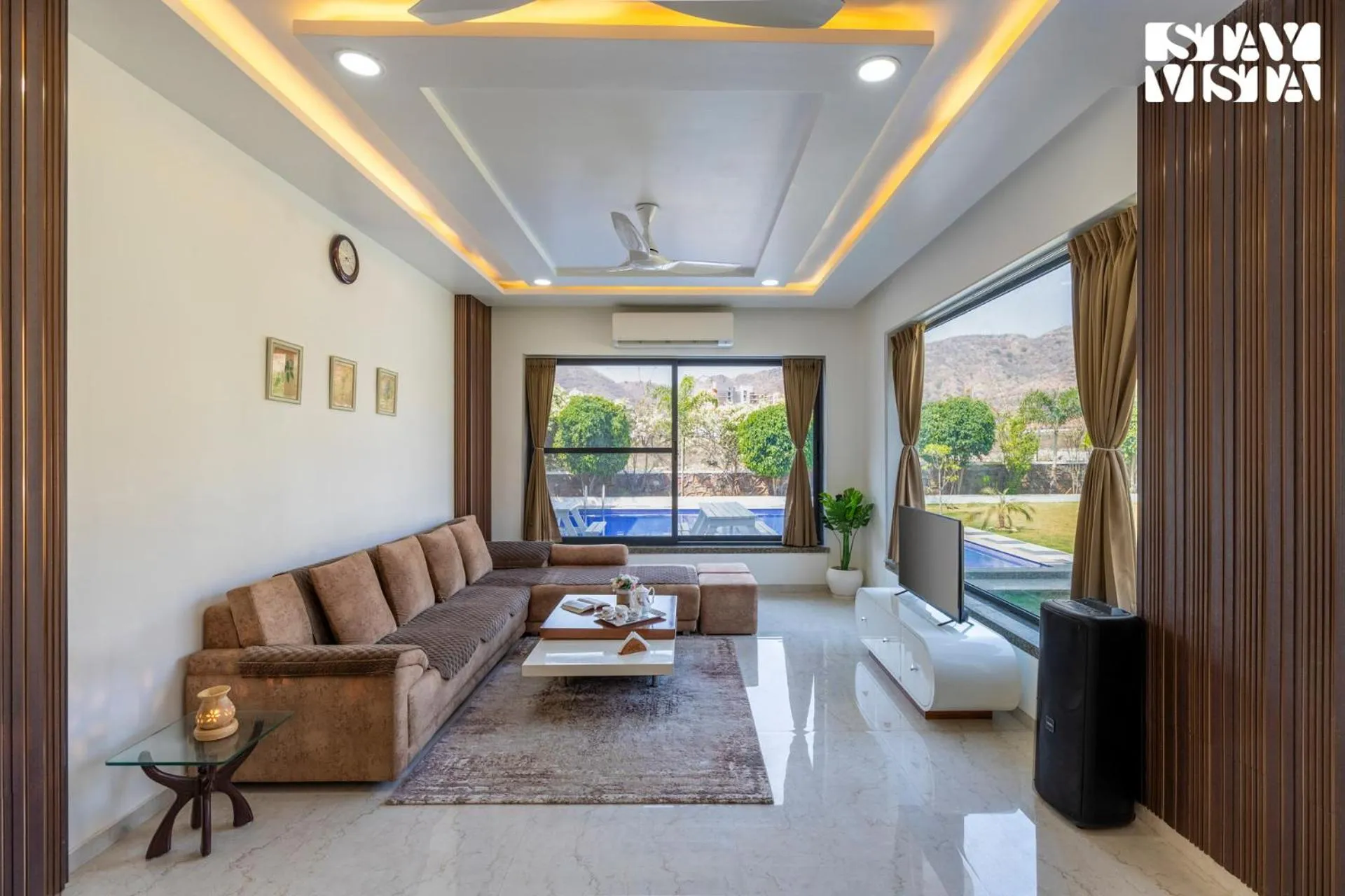 Living room in StayVista's Bella Dream - Mountain-View with Outdoor Pool, Lawn featuring a Gazebo & Indoor Games