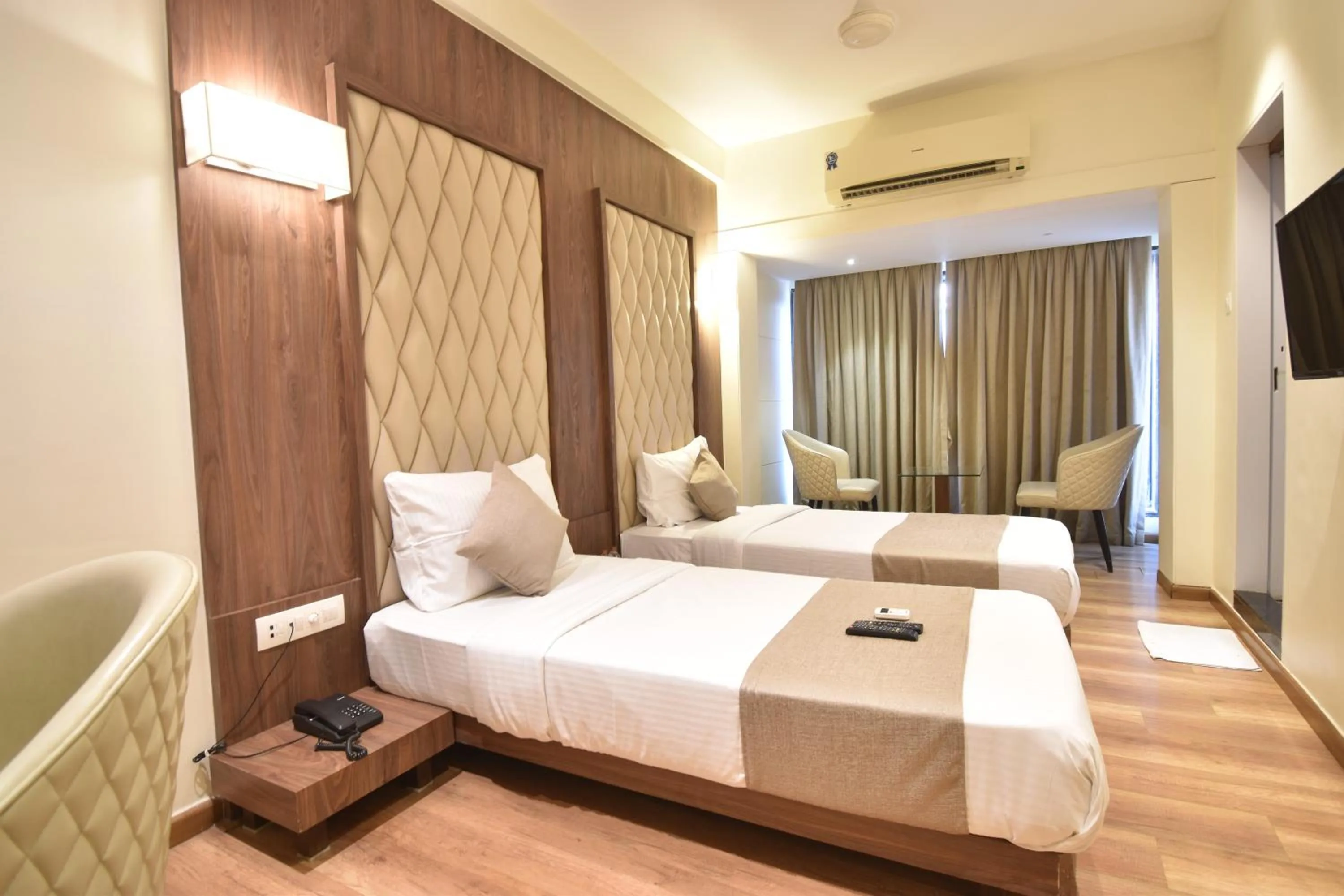 Bed in The Aarya A Smart Business Hotel