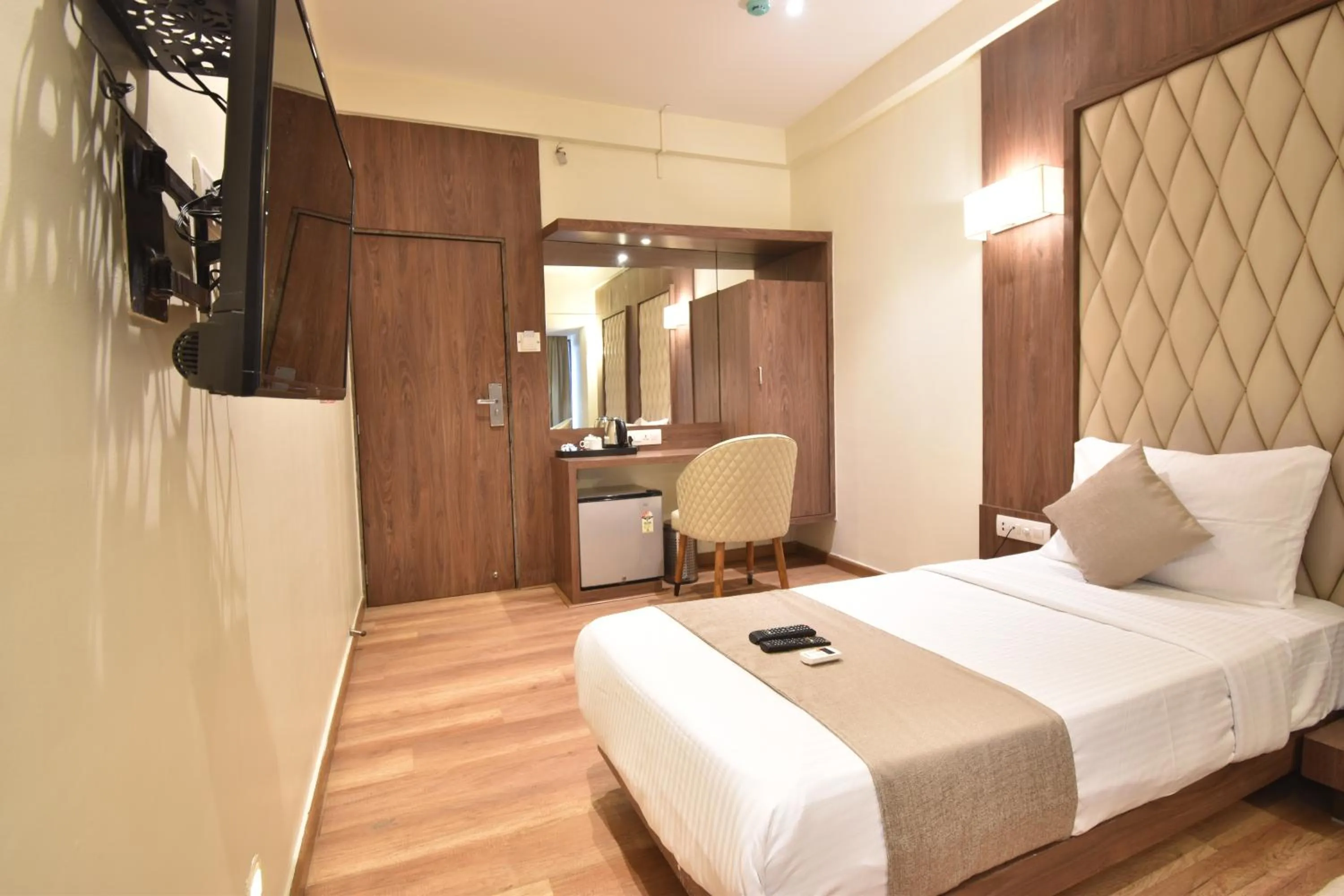 Bed in The Aarya A Smart Business Hotel