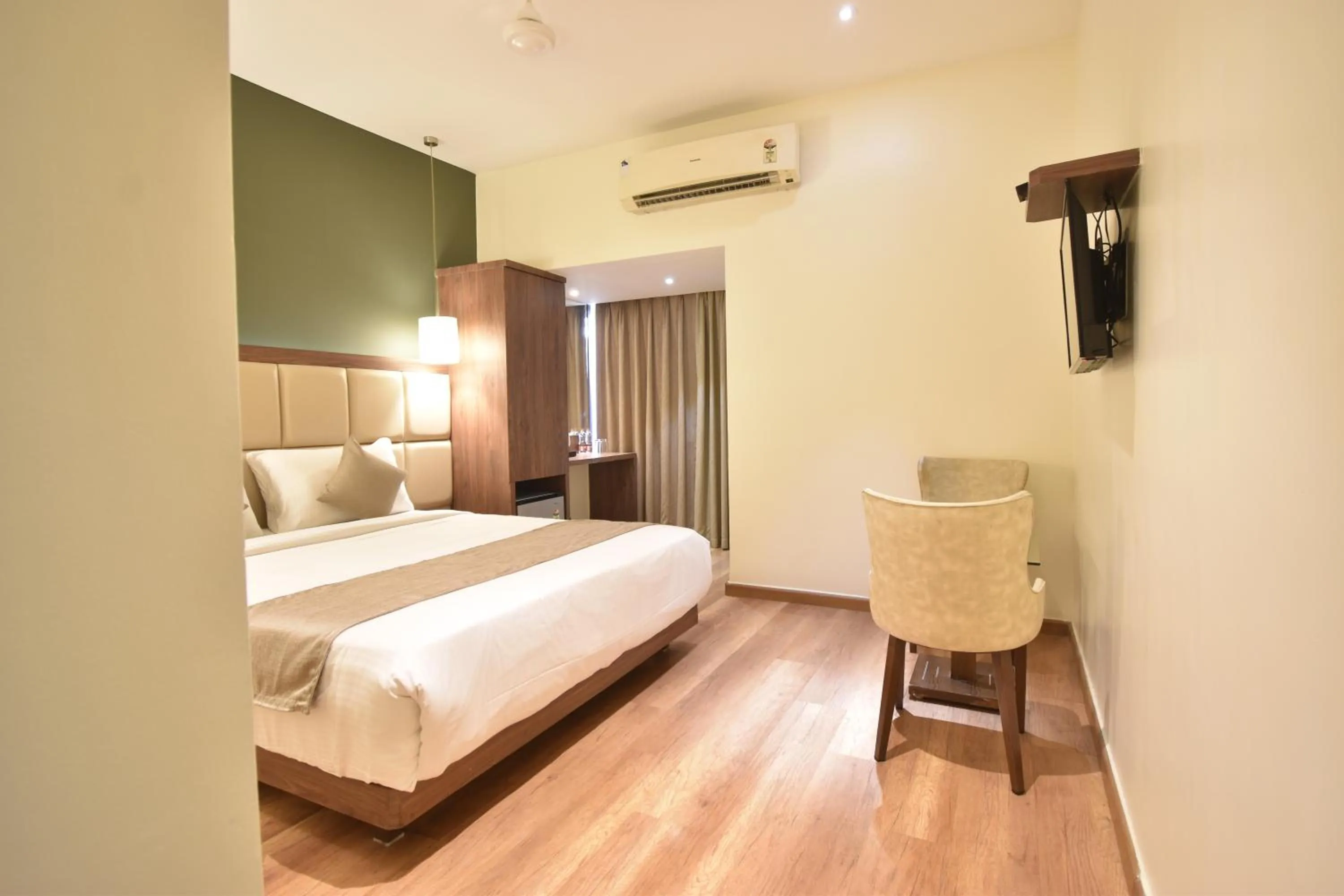 Seating area, Bed in The Aarya A Smart Business Hotel