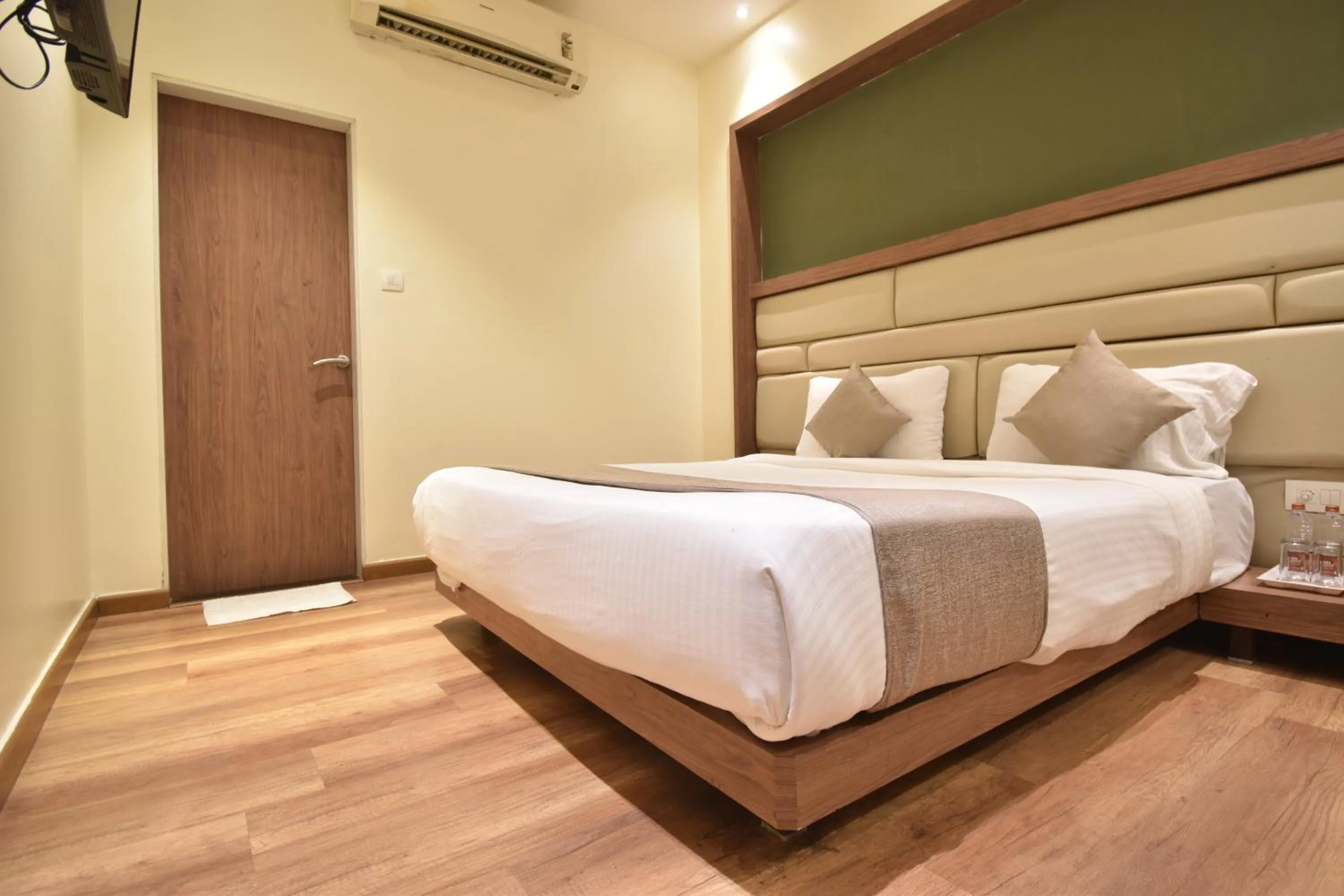 Bed in The Aarya A Smart Business Hotel