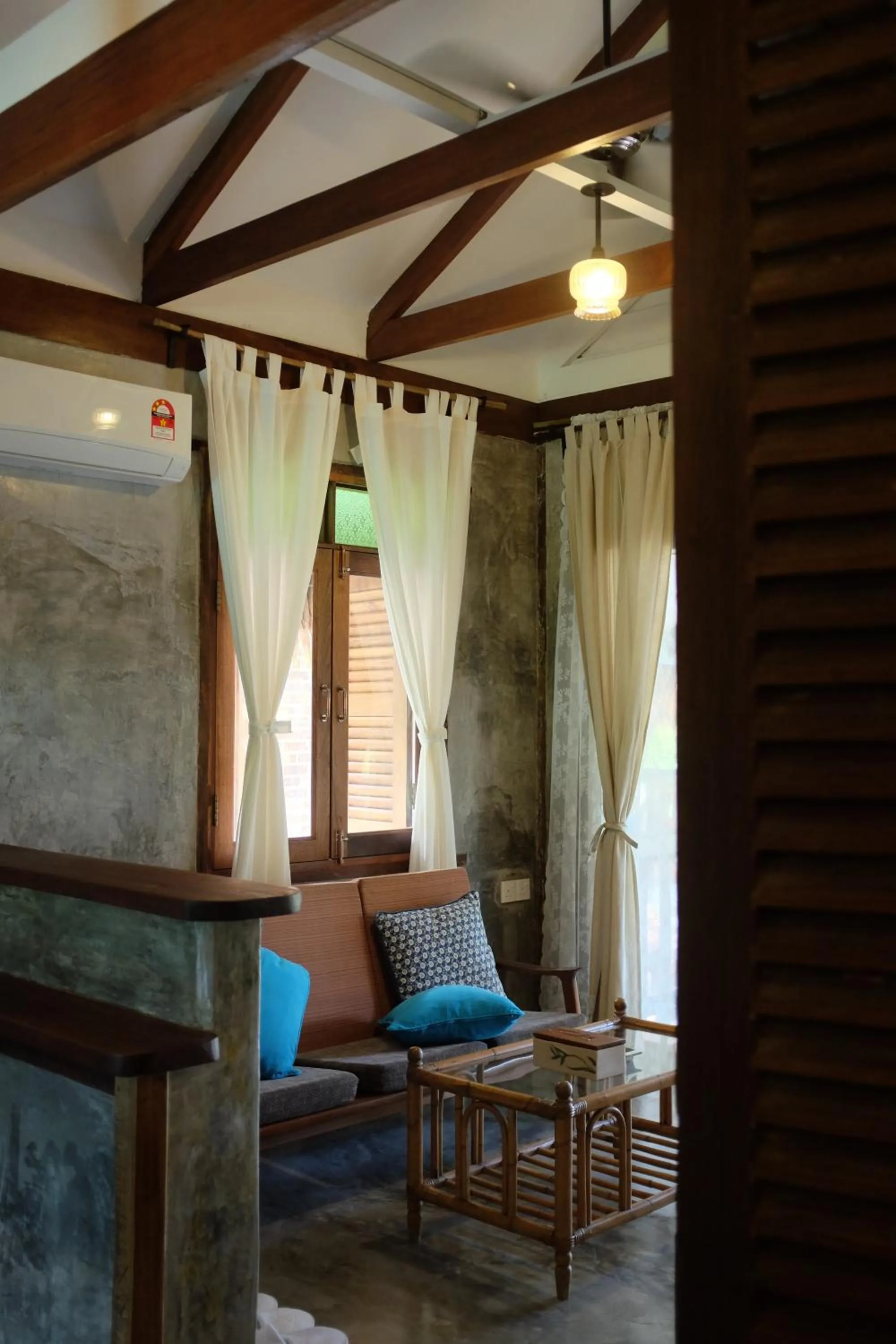 Communal lounge/ TV room in Panji Panji Tropical Wooden Home