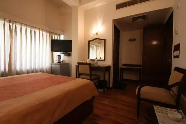Bed, TV/Entertainment Center in Hotel Crystal Palace Meerut Bed, TV/Entertainment Center in Hotel Crystal Palace Meerut