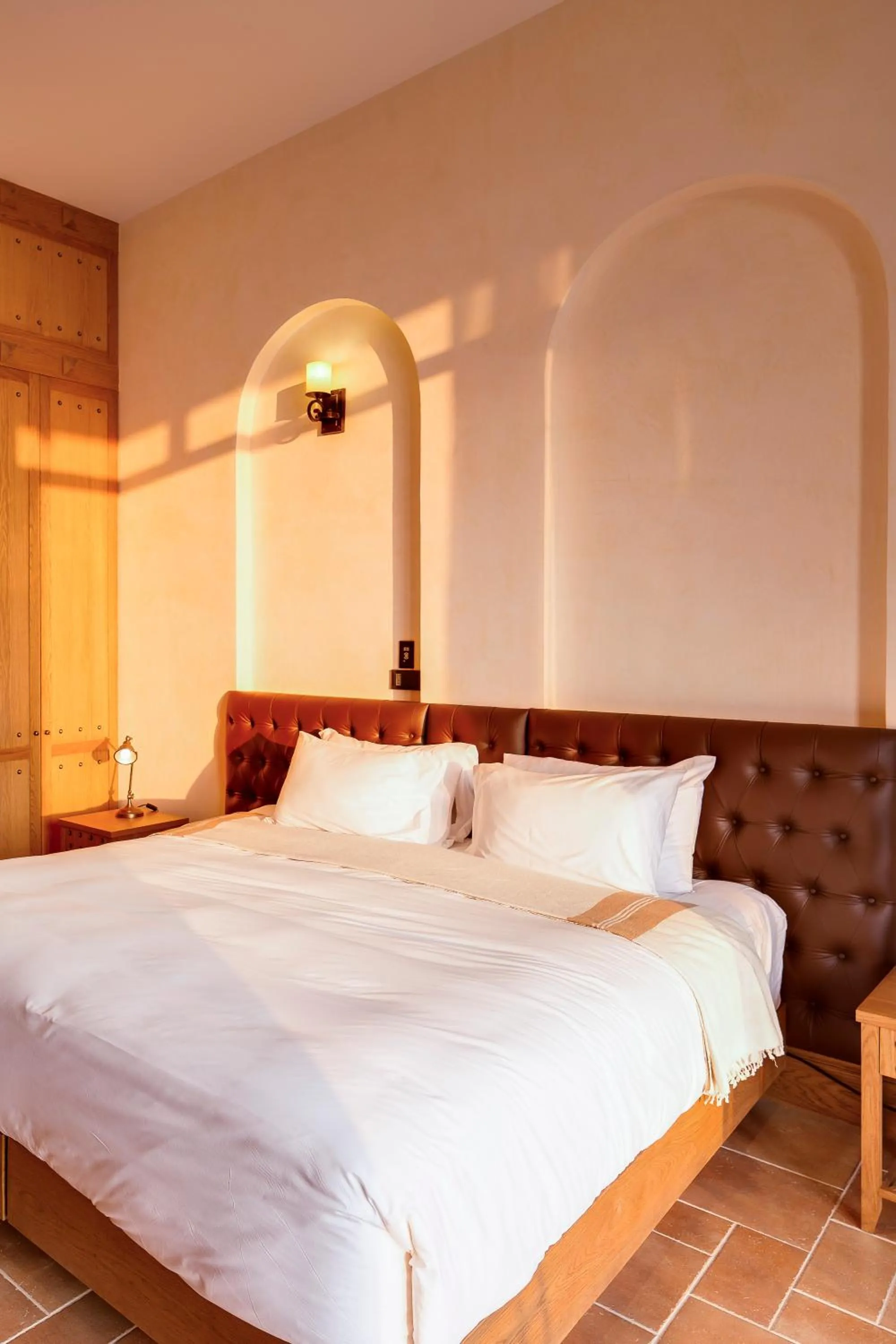 Bed in Toscana Town Square Suites