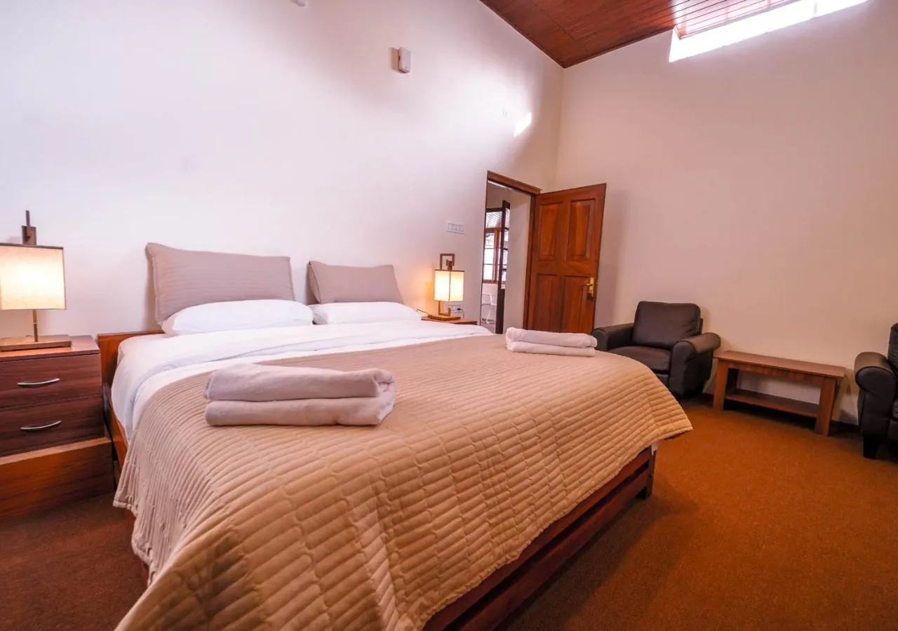 Bed in Lauriston Ooty Town Heritage Bungalow by VOYE HOMES