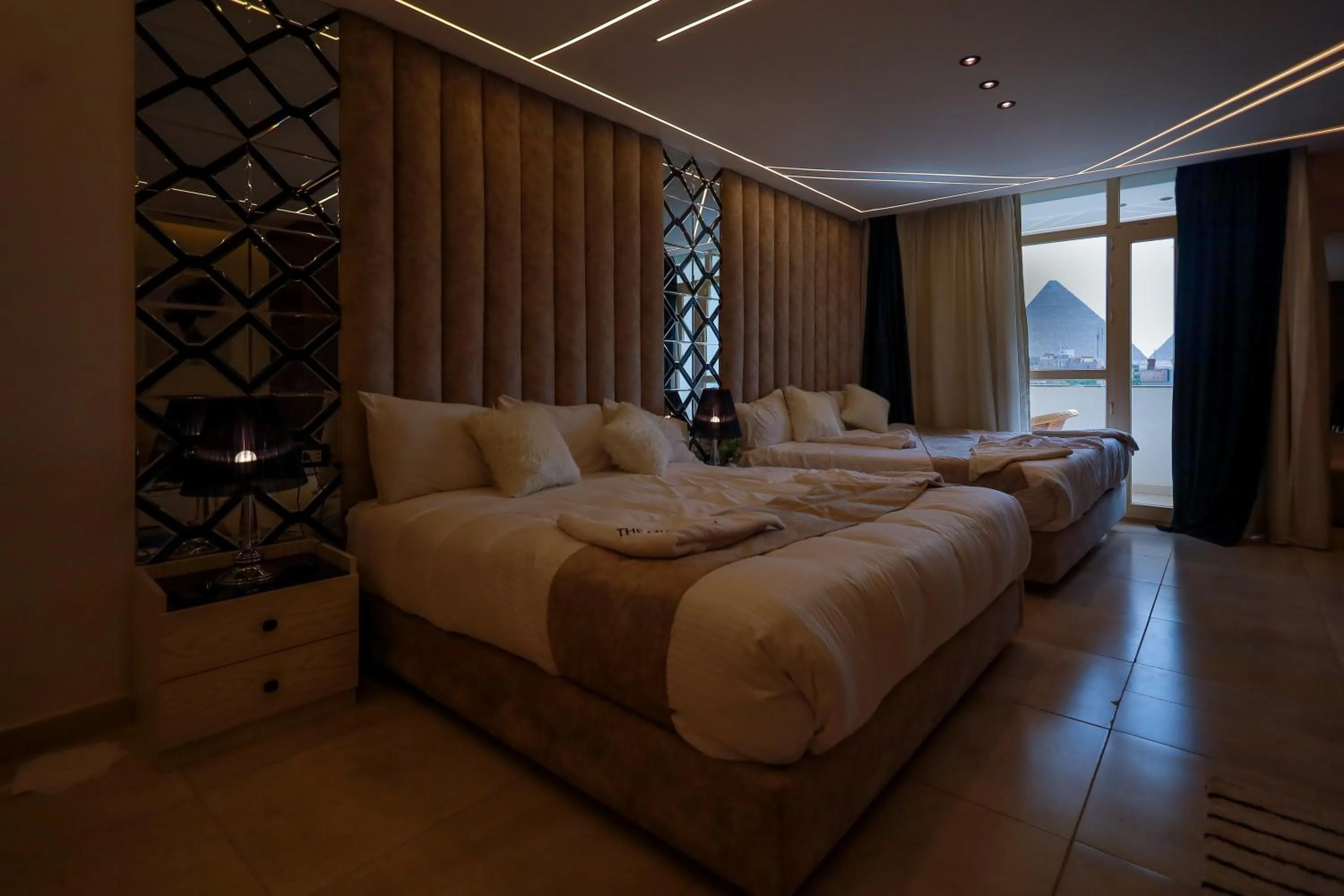 Bed in The Muse Pyramids INN