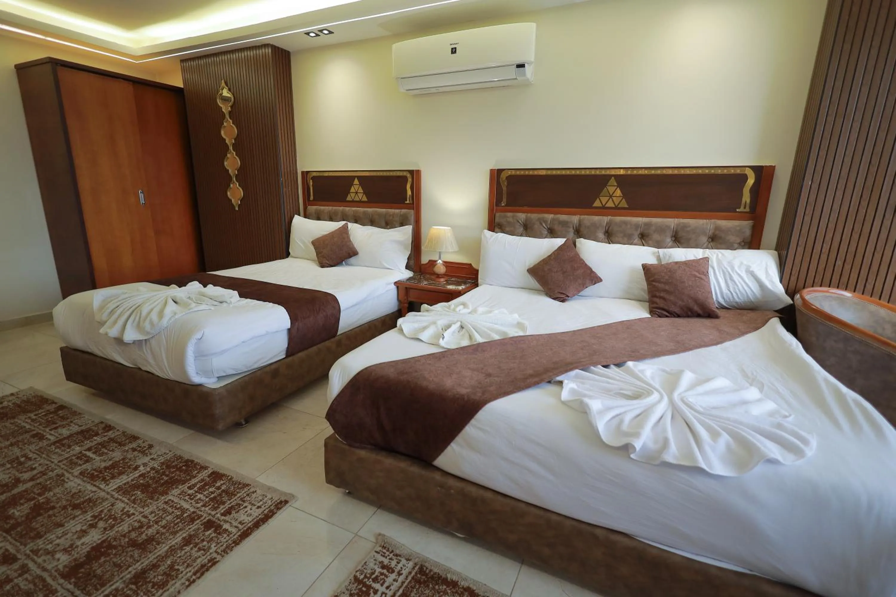 Bed in The Muse Pyramids INN