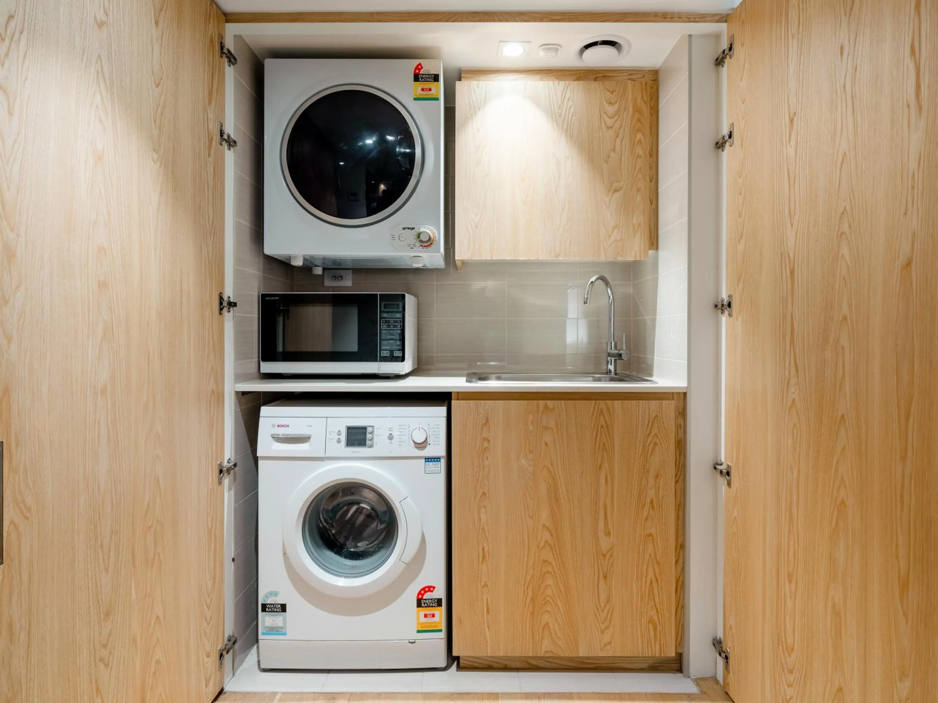 washing machine in Bondi Pacific Studio - Managed by X Hospitality