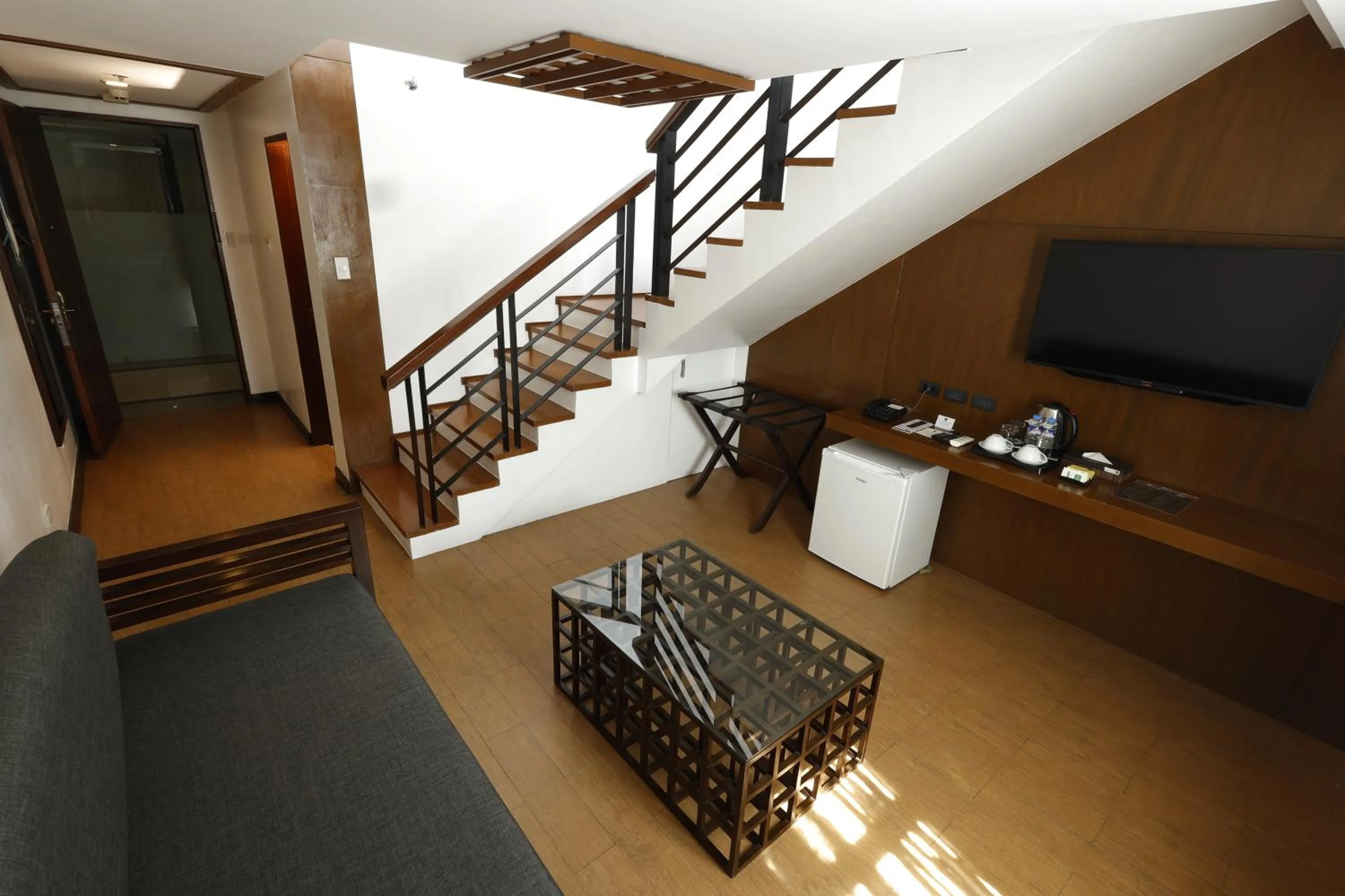 Communal lounge/ TV room in The Harvest Hotel Managed by HII