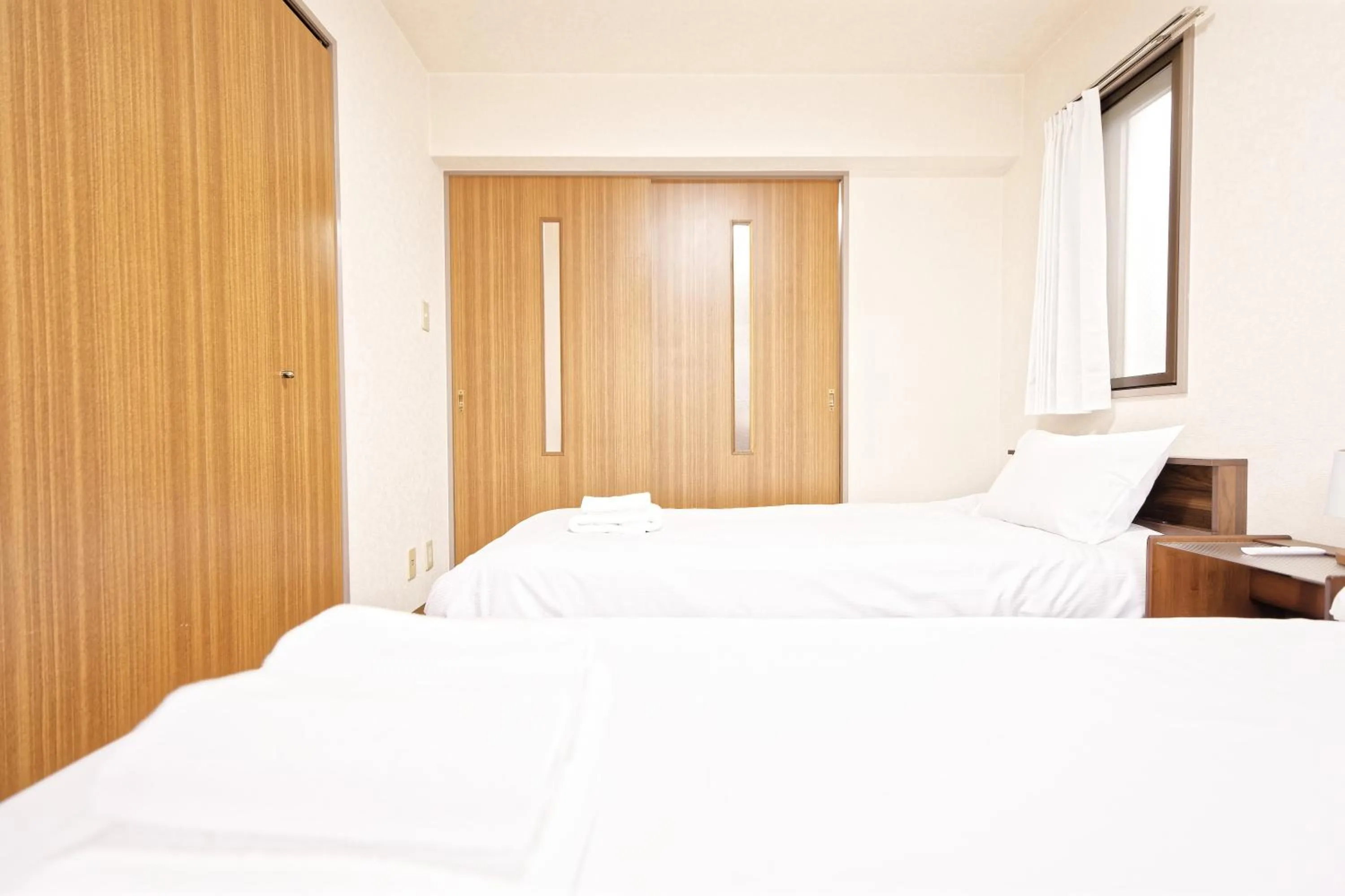 Bed in Shinjuku Waseda Earthtone Apartment