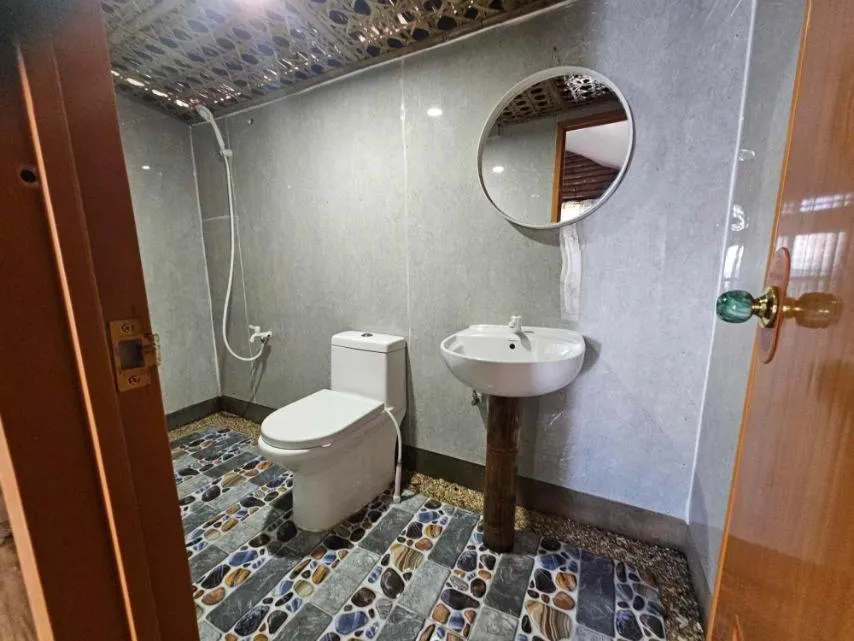 Bathroom in Tambayan Rooms and Cottages by SMS Hospitality
