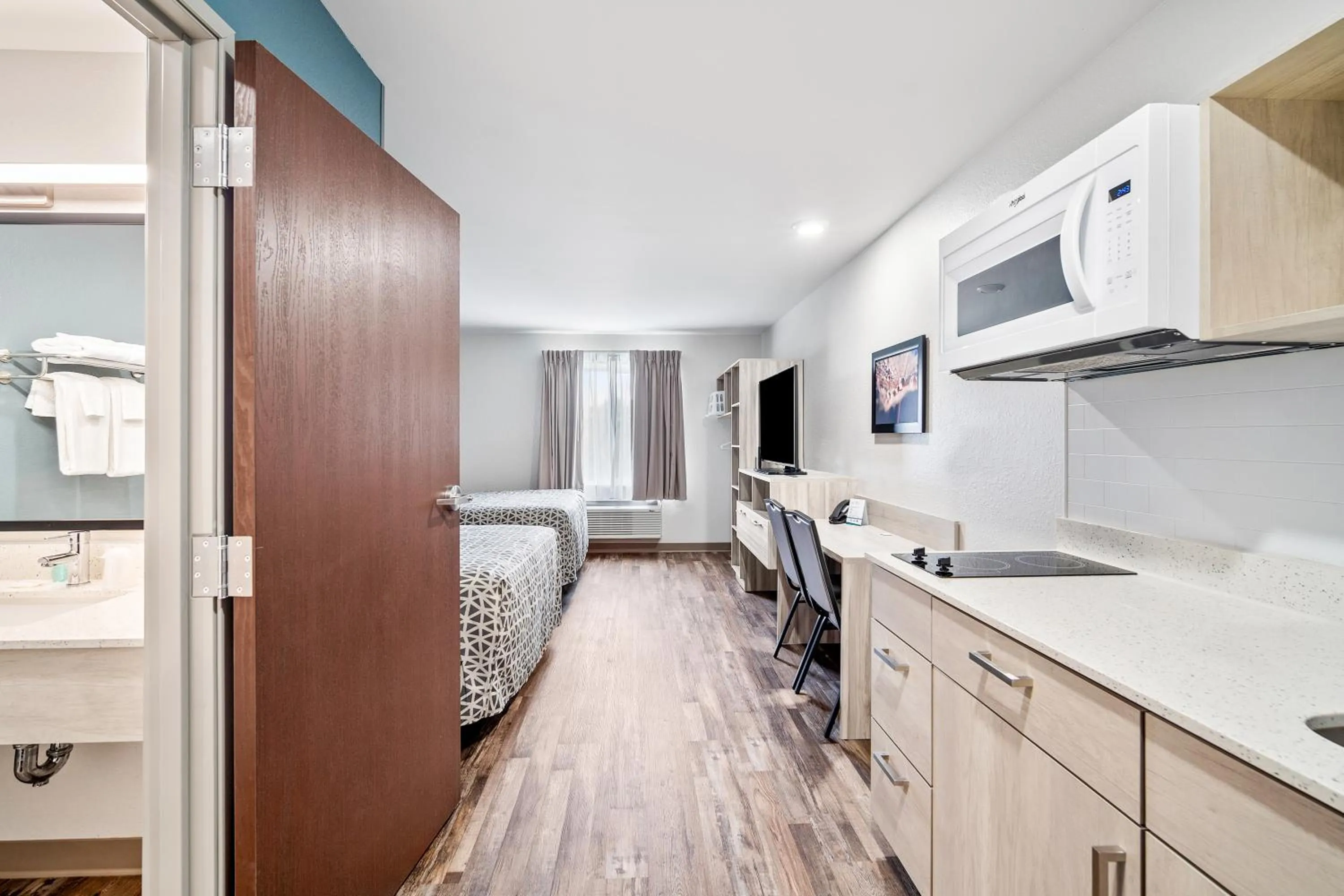 Kitchen or kitchenette, Bed in WoodSpring Suites Winston-Salem near Hanes Mall