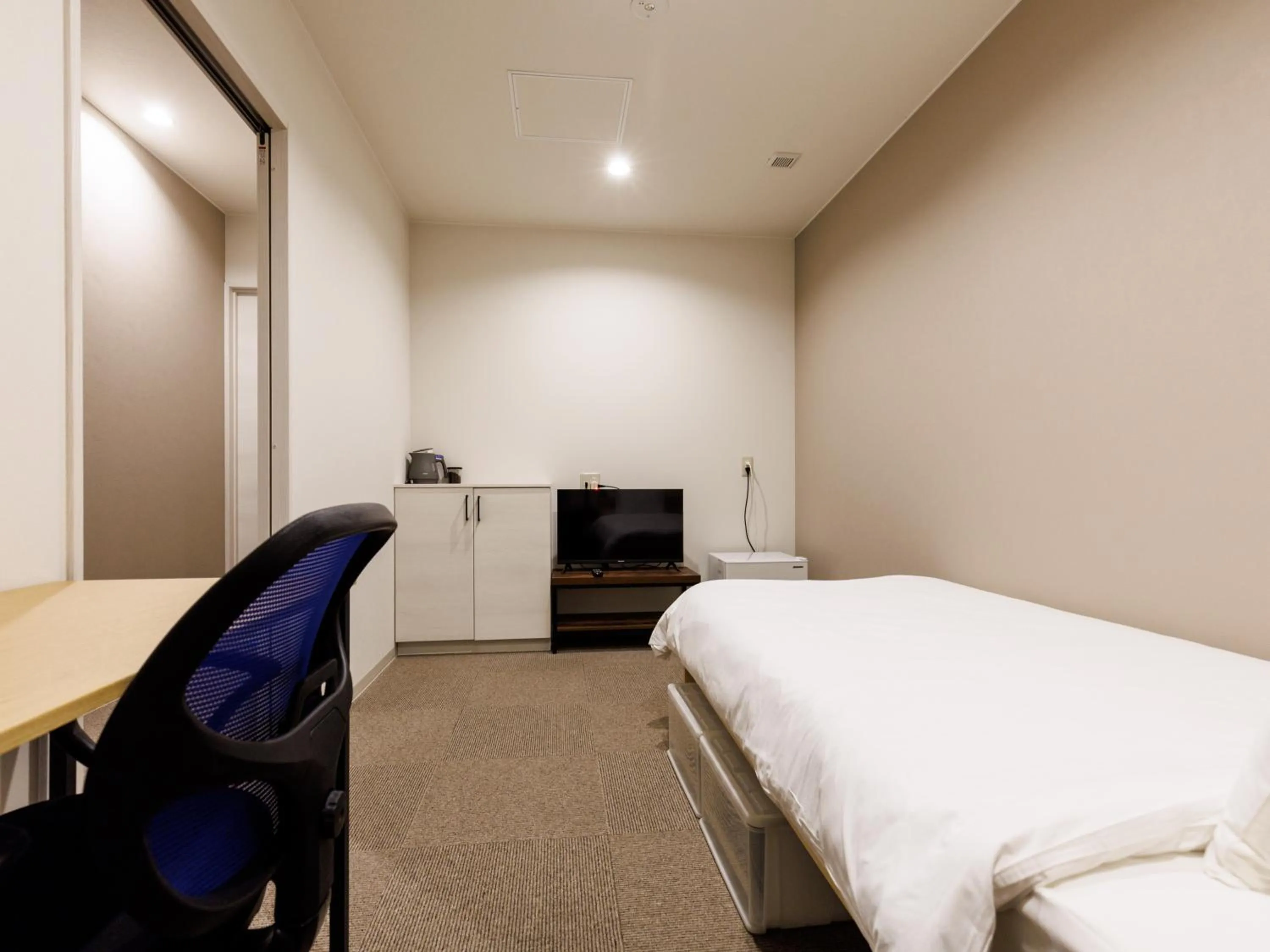 Bed in Tabist Kitami Athlete Stays