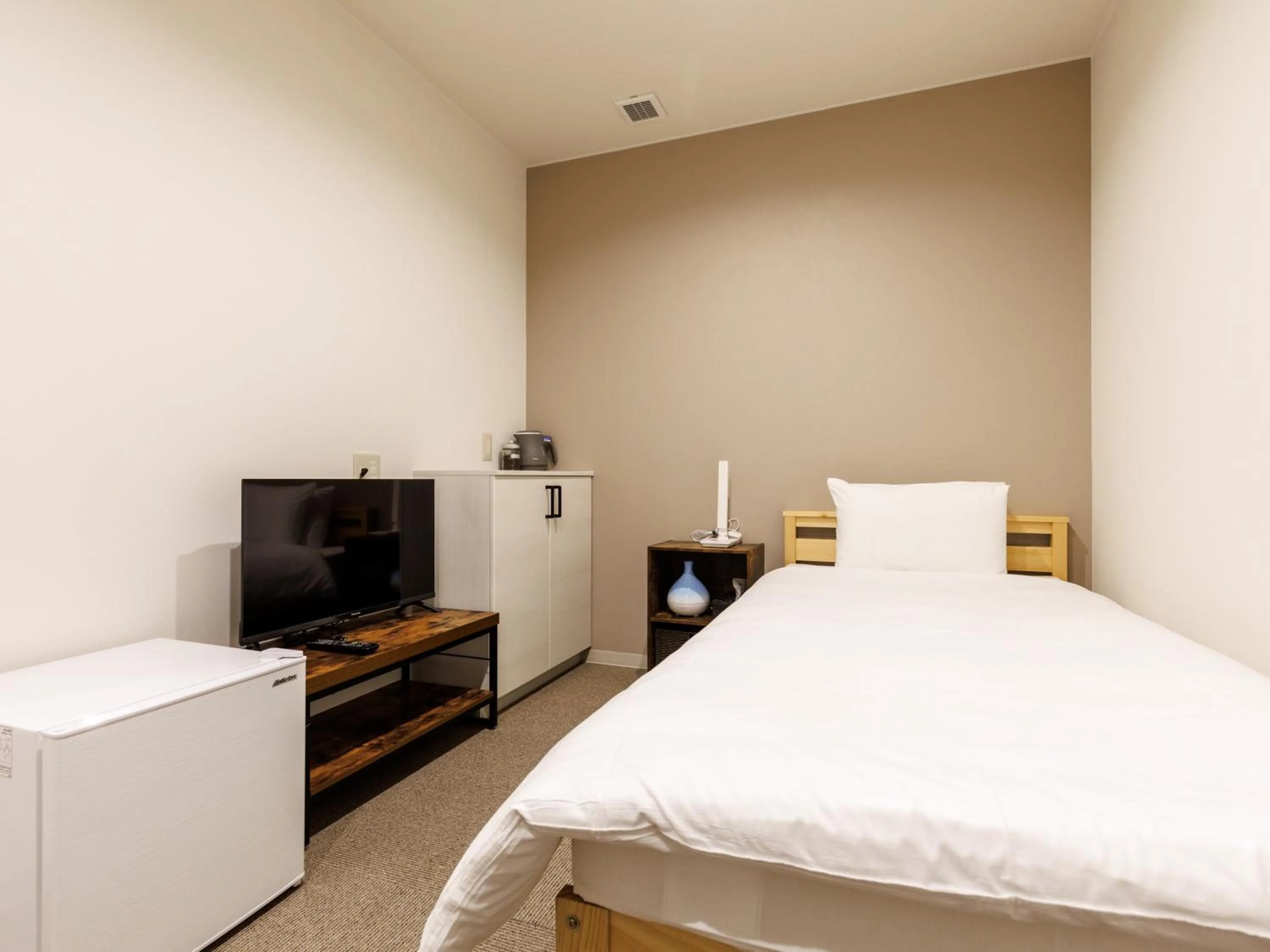 Bed in Tabist Kitami Athlete Stays