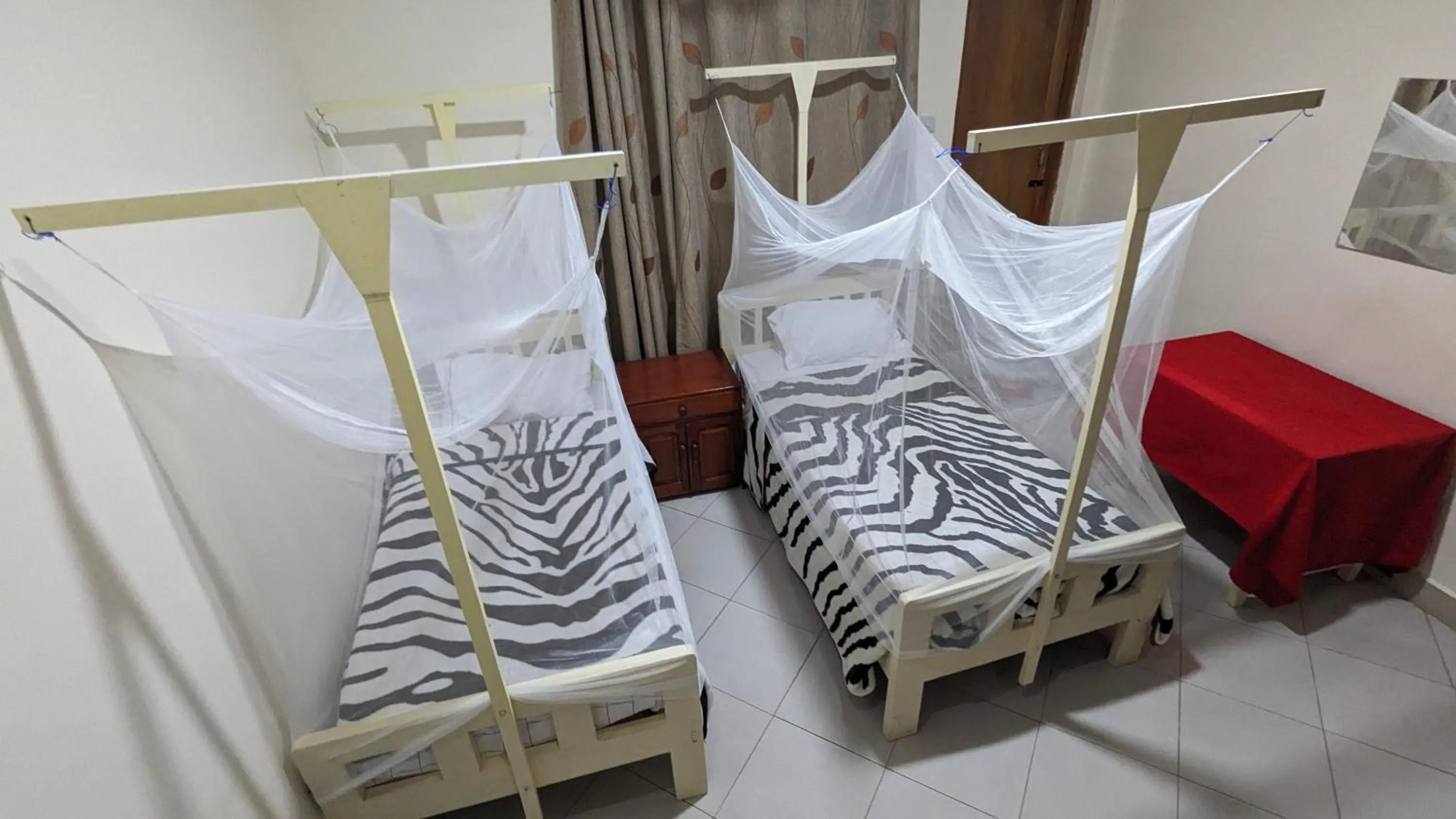 Bed in JACARANDA HOMESTAY