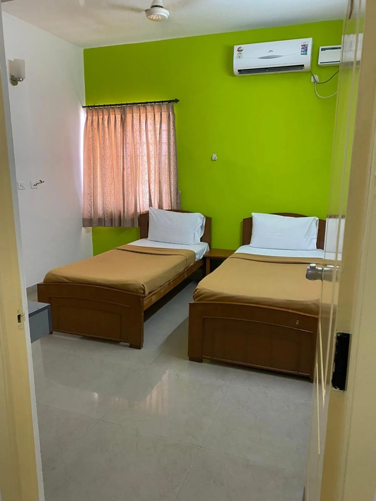 Bed in ThulasiRams Service Apartments