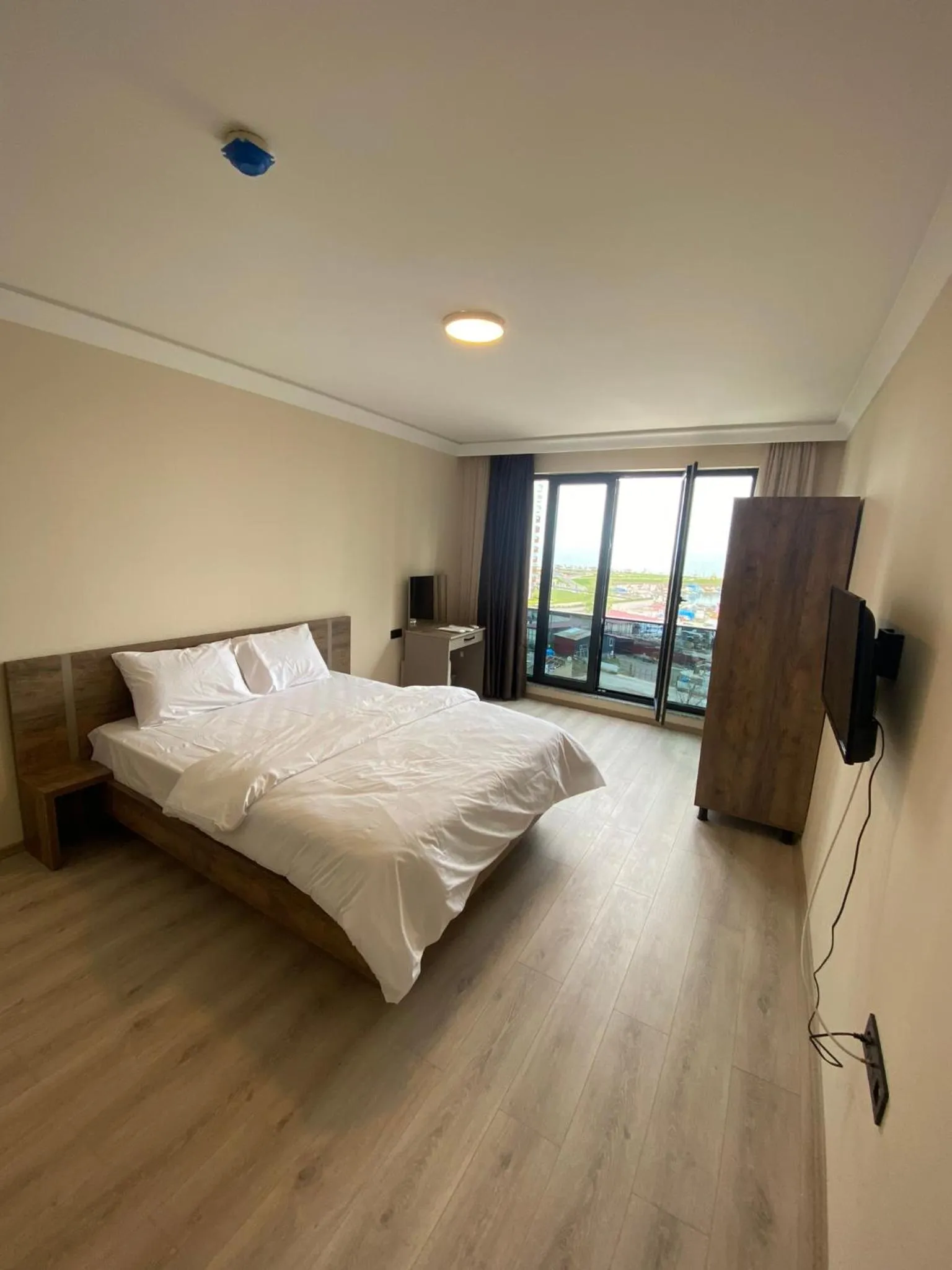 Communal lounge/ TV room, Bed in Rena Grand Residence & Suit