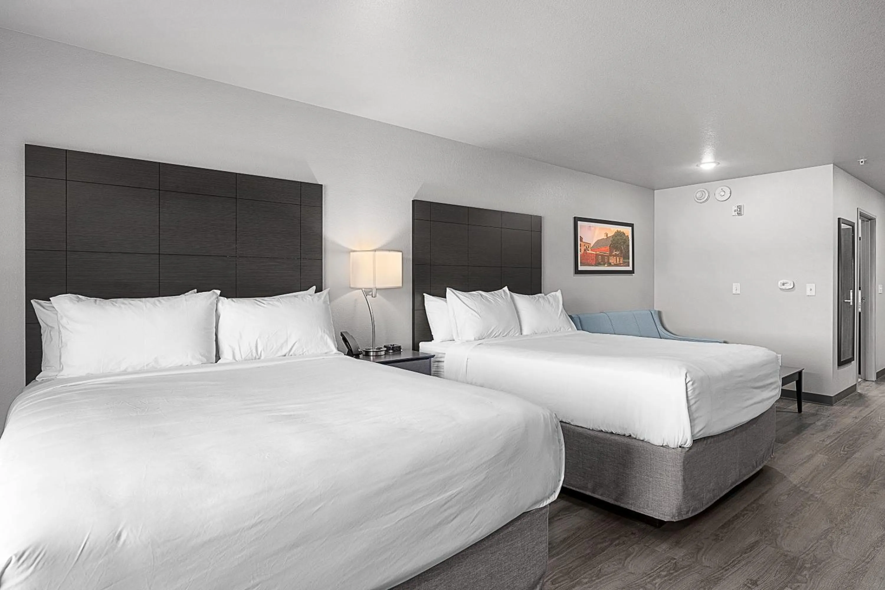 Bedroom, Bed in Riverstone Suites by Cobblestone Hotels - Chippewa Falls