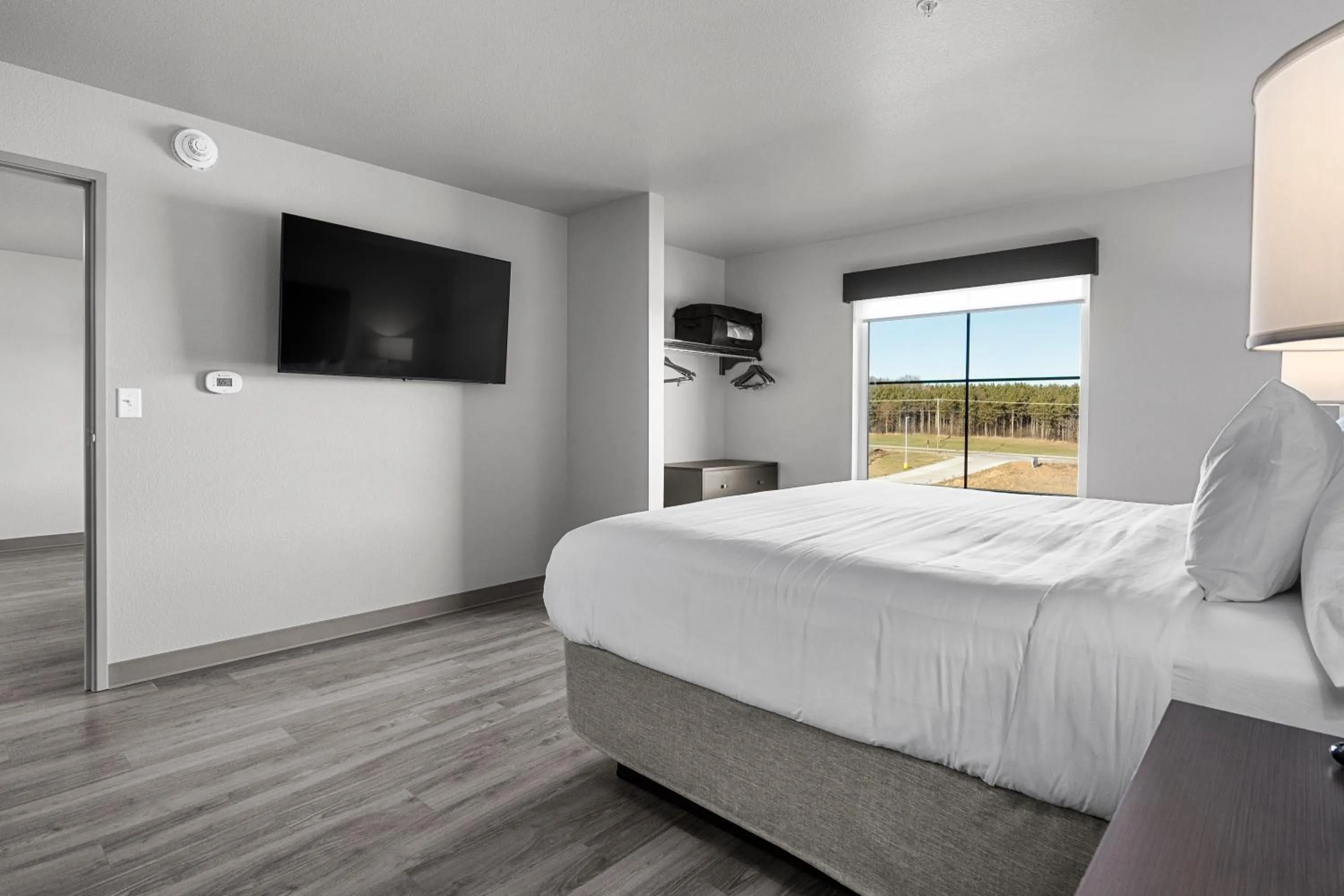 Bedroom, Bed in Riverstone Suites by Cobblestone Hotels - Chippewa Falls