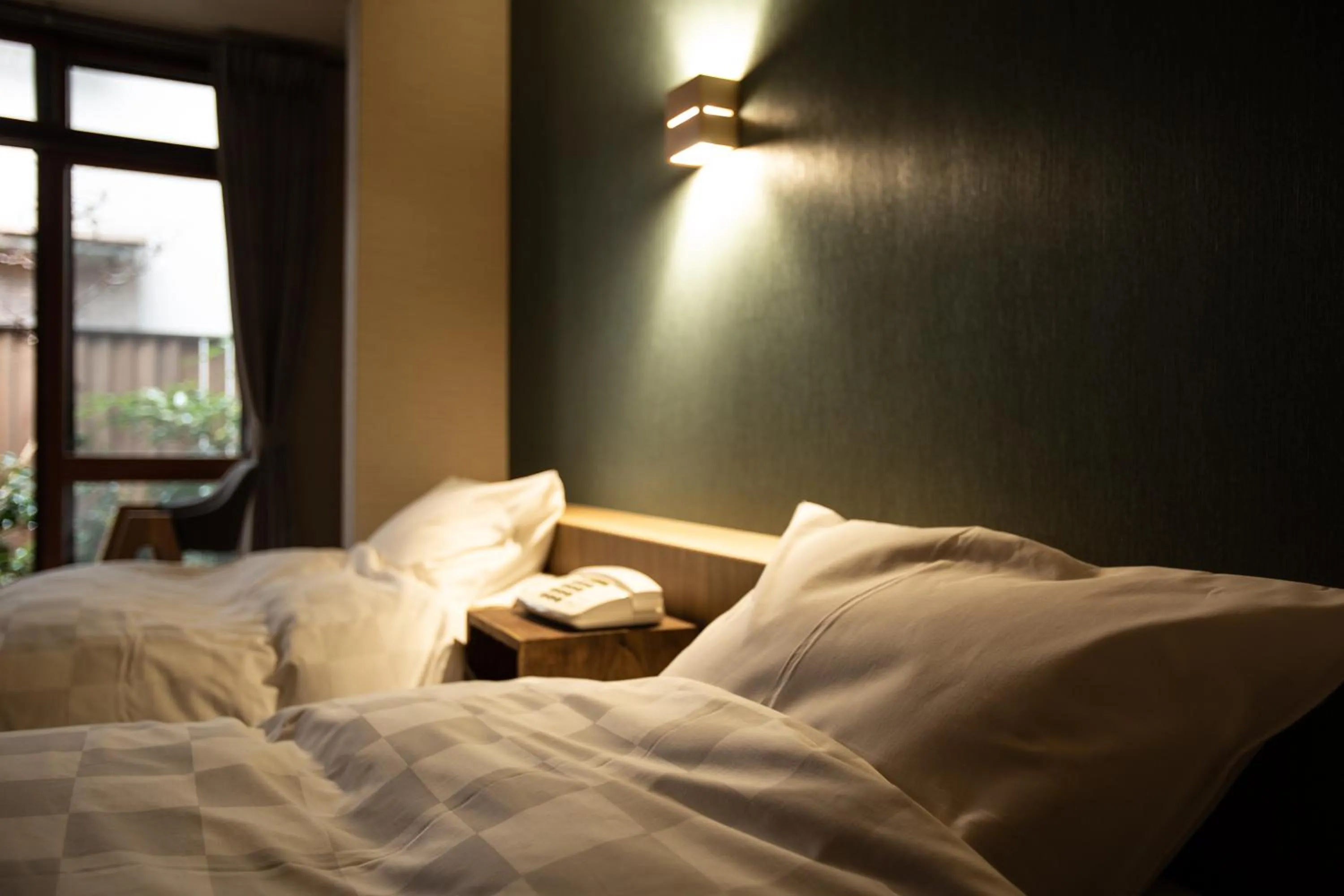 Bed in 城崎温泉 旅館 つばき乃 - Kinosaki Onsen Ryokan Tsubakino