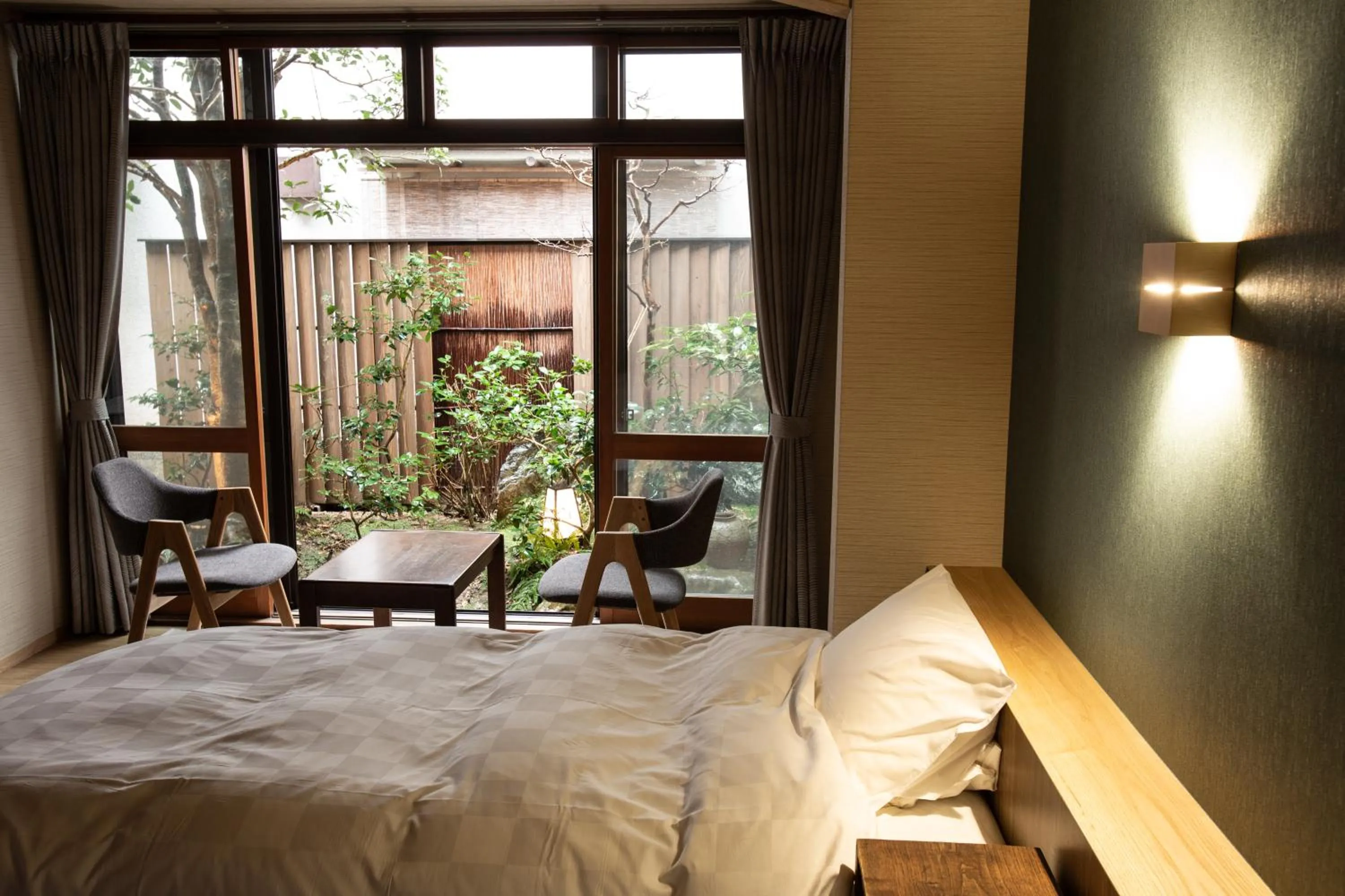 Bed in 城崎温泉 旅館 つばき乃 - Kinosaki Onsen Ryokan Tsubakino