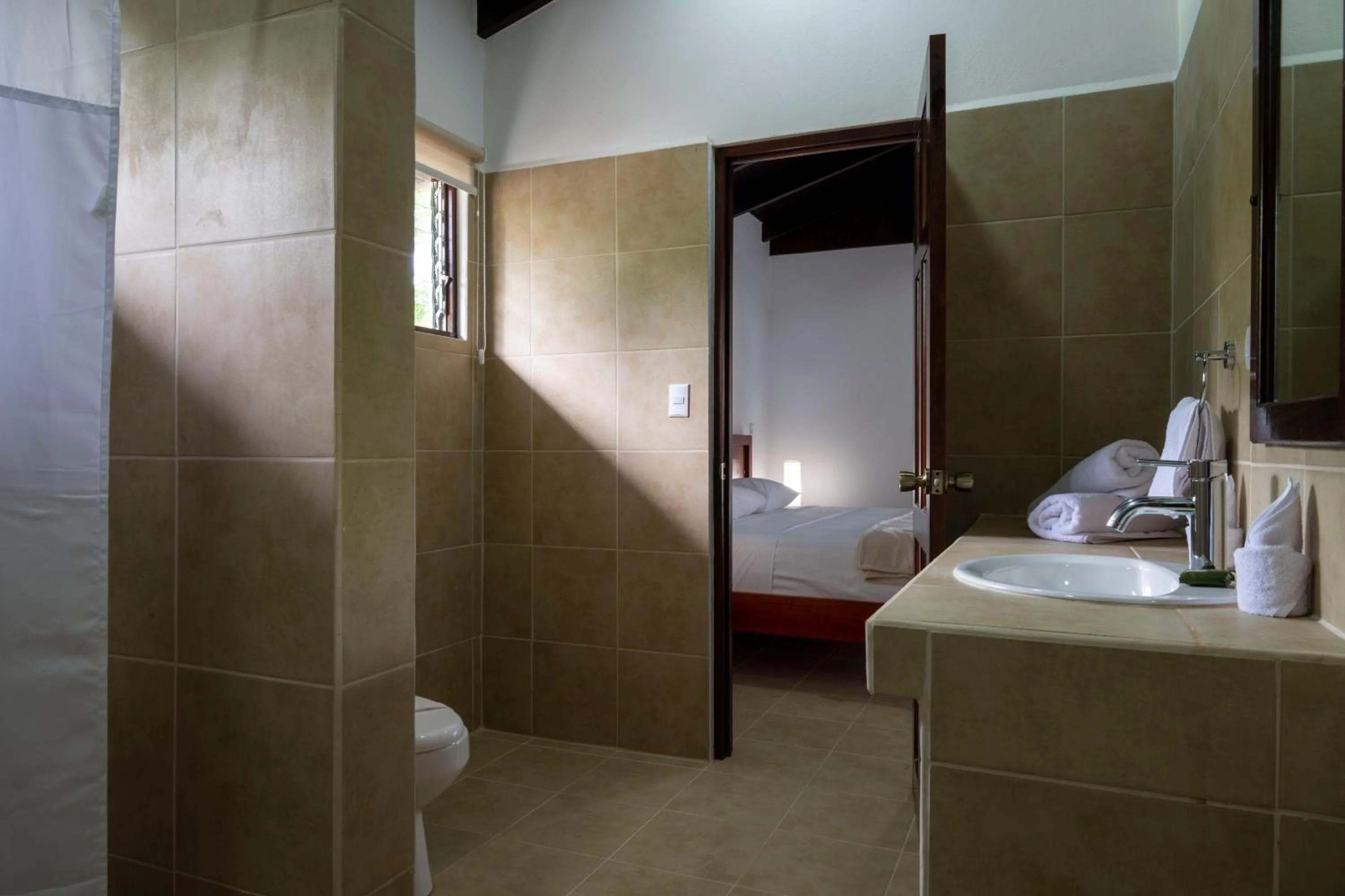 Bathroom, Bed in Fuego del Sol Beachfront Hotel