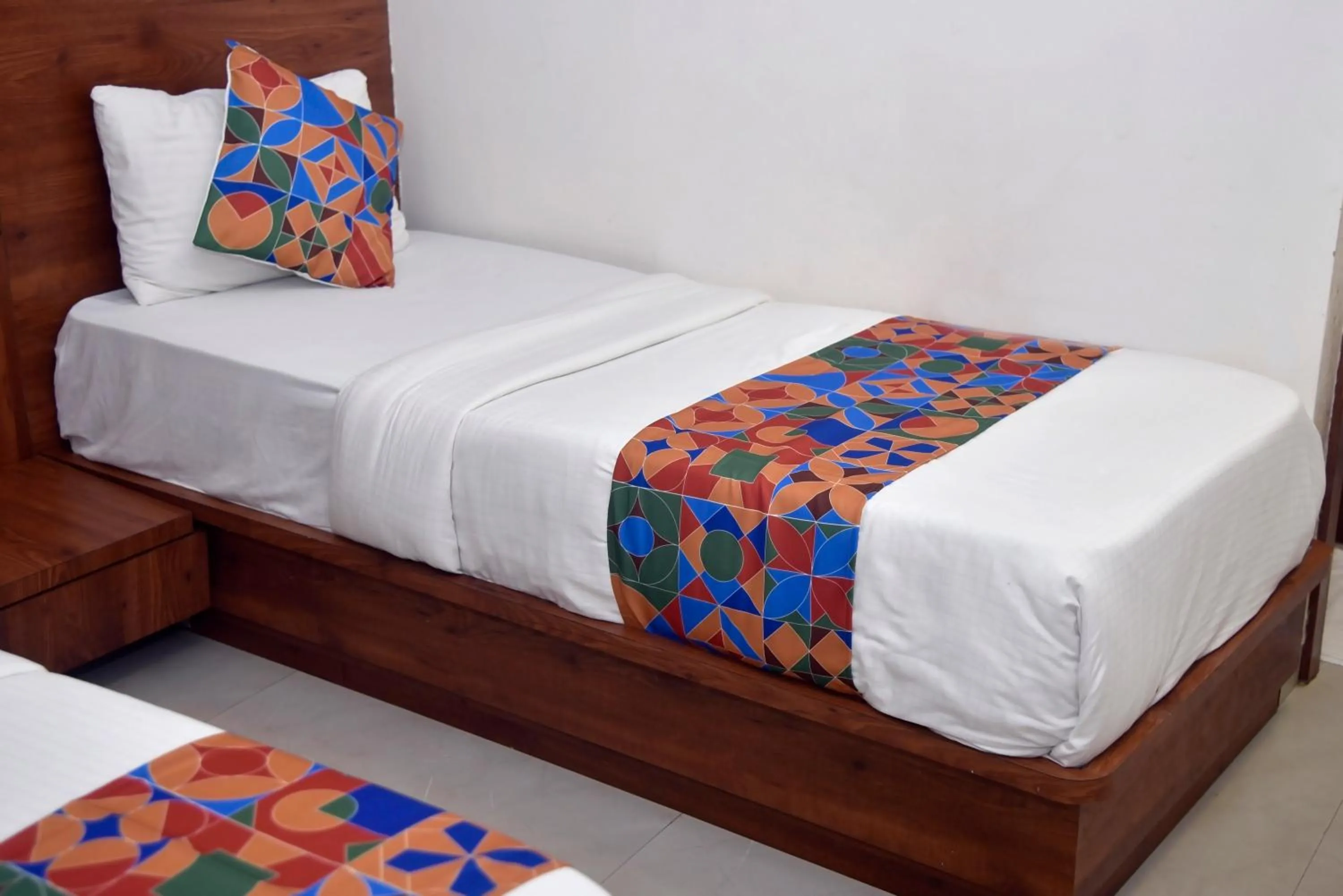 Bed in Hotel Pride Inn