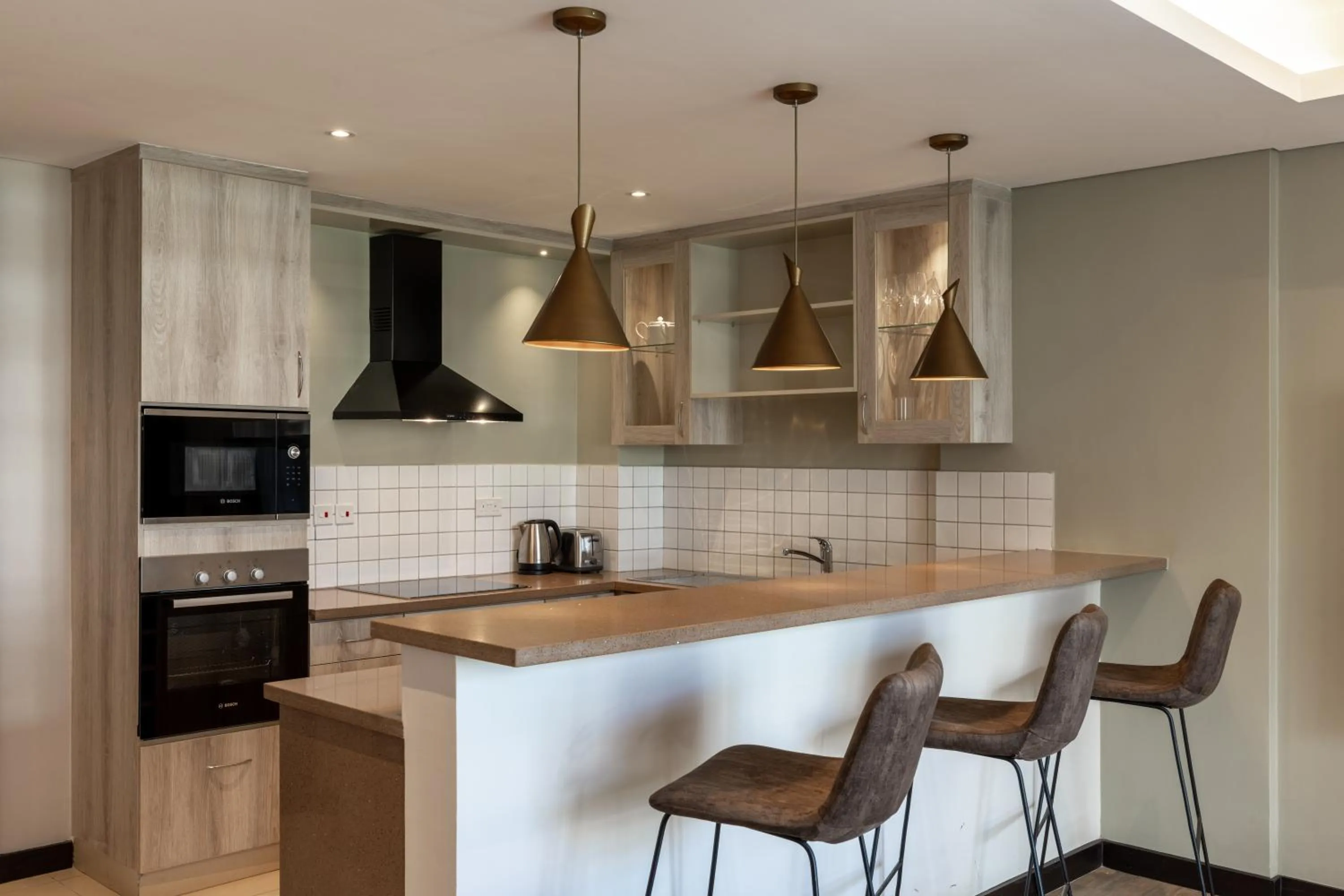 Kitchen or kitchenette in Trademark Suites at Enaki Town