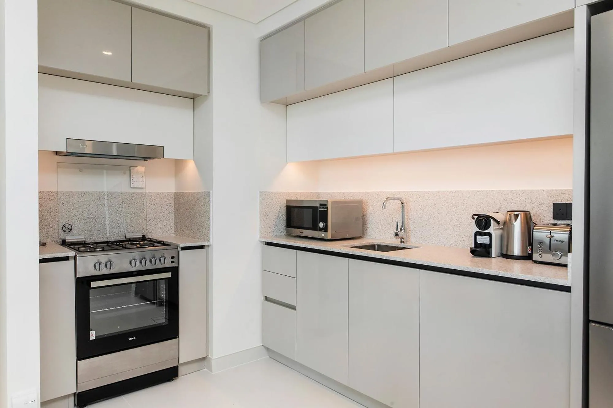 Kitchen or kitchenette in Chic Apartments in Marina Vista Emaar Beachfront
