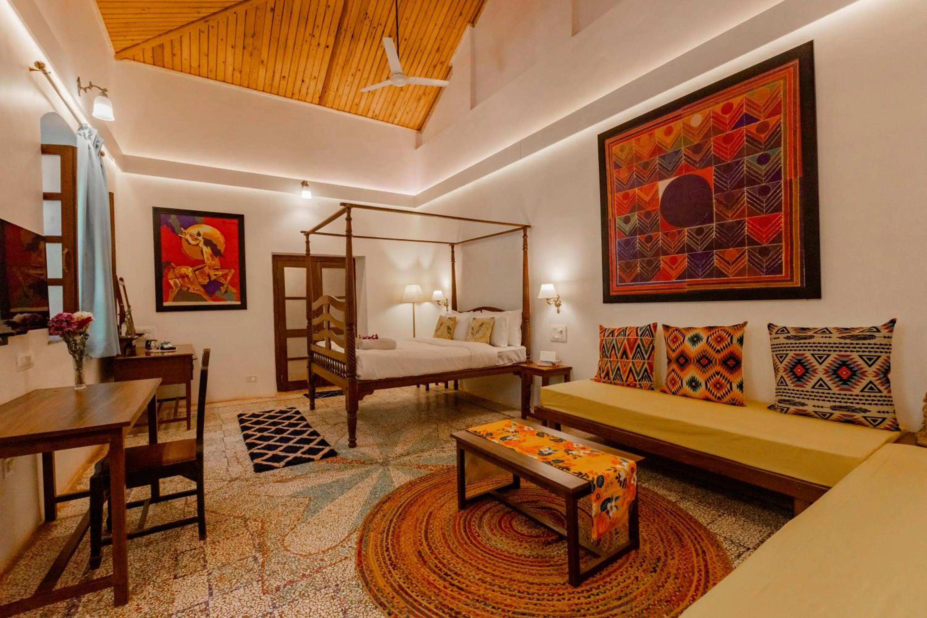 Seating area, Bed in Radha Cottage Resort