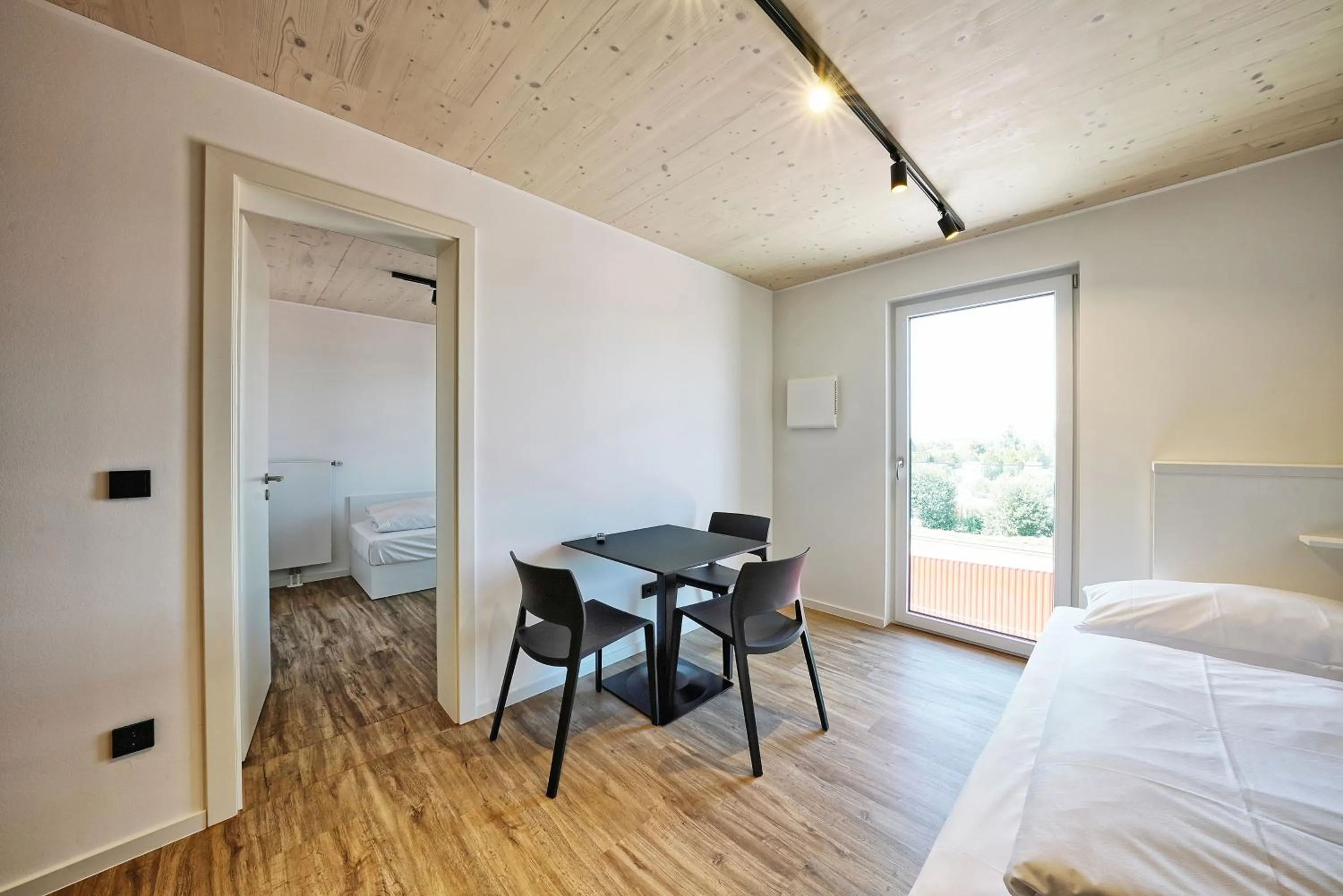 Seating area, Bed in Timber One Boardinghouse Dorfen