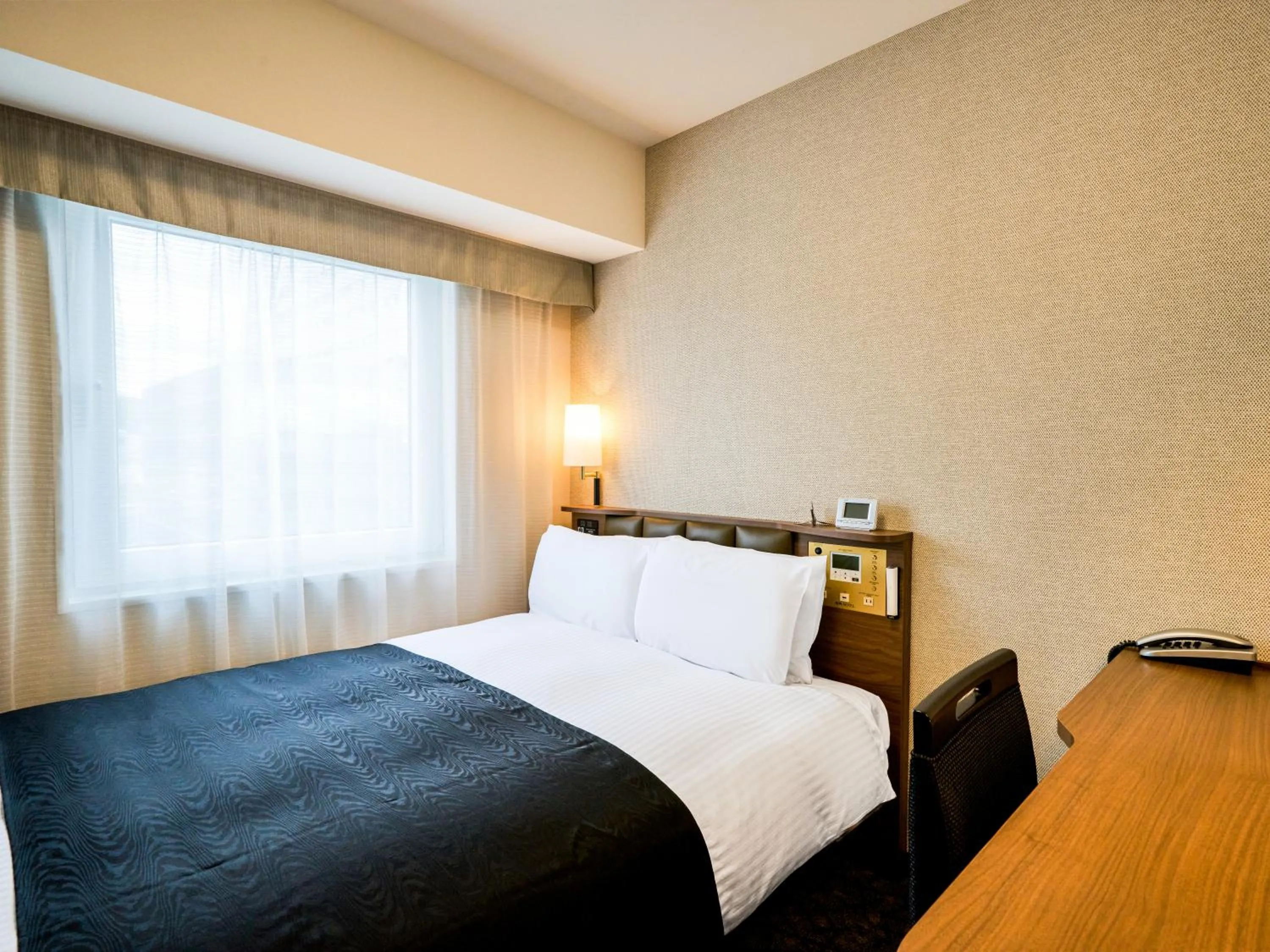 Photo of the whole room, Bed in APA Hotel Hiroshima Ekimae Shinkansenguchi