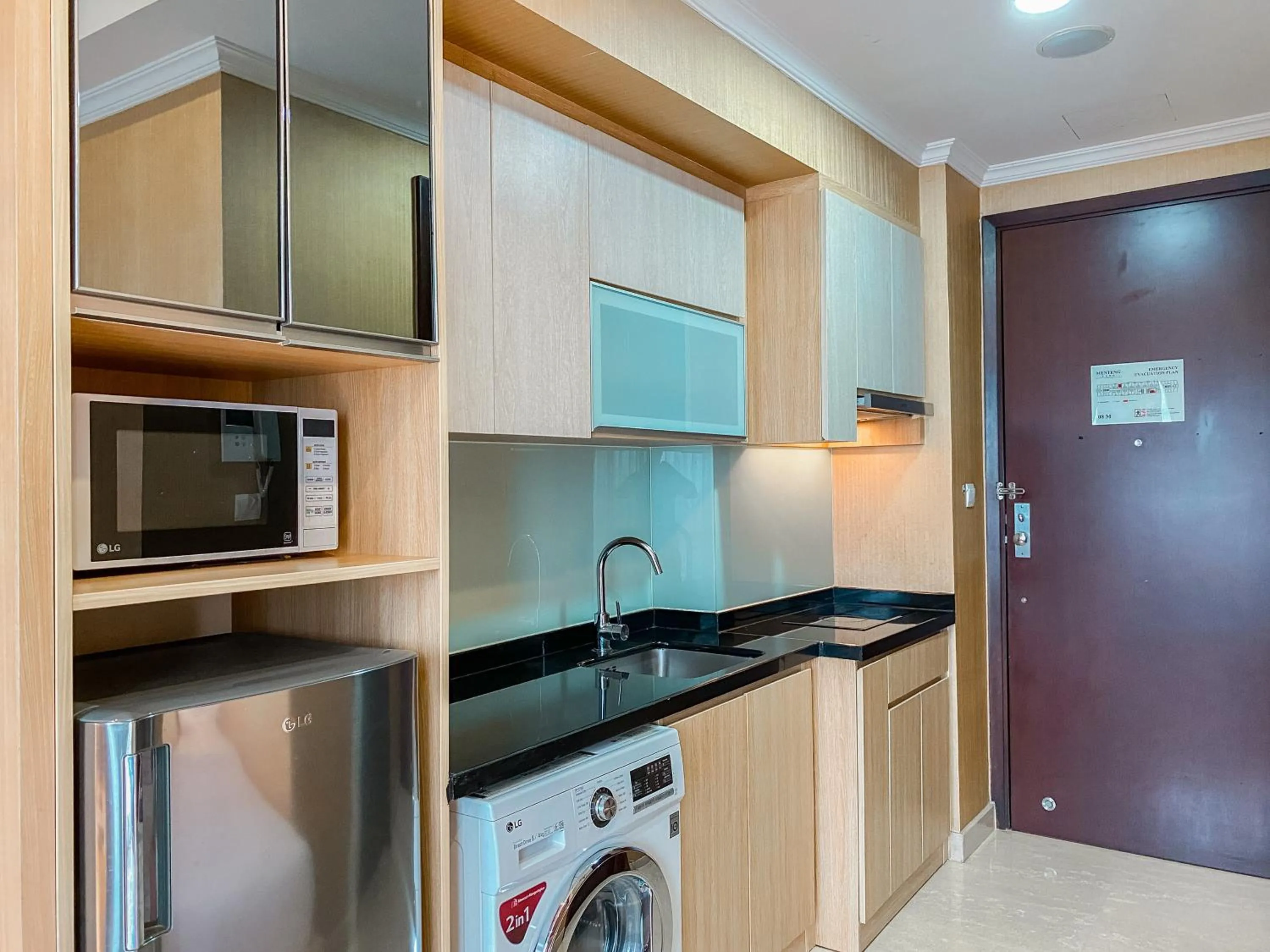 Kitchen or kitchenette in Lovely Studio Menteng Park Apartment By Travelio