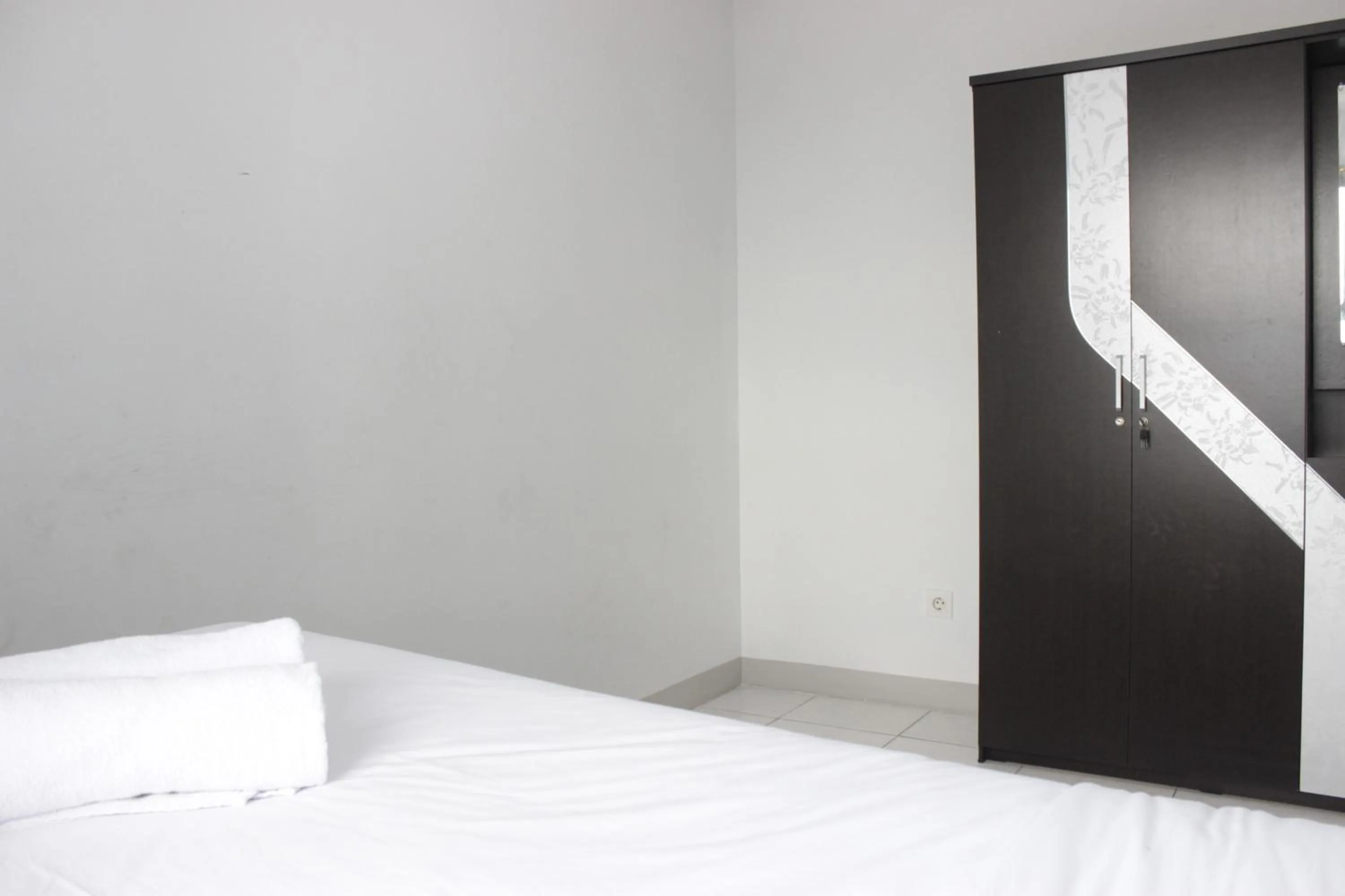 Bed in Comfy 2BR Apartment at Mekarwangi Square Cibaduyut By Travelio