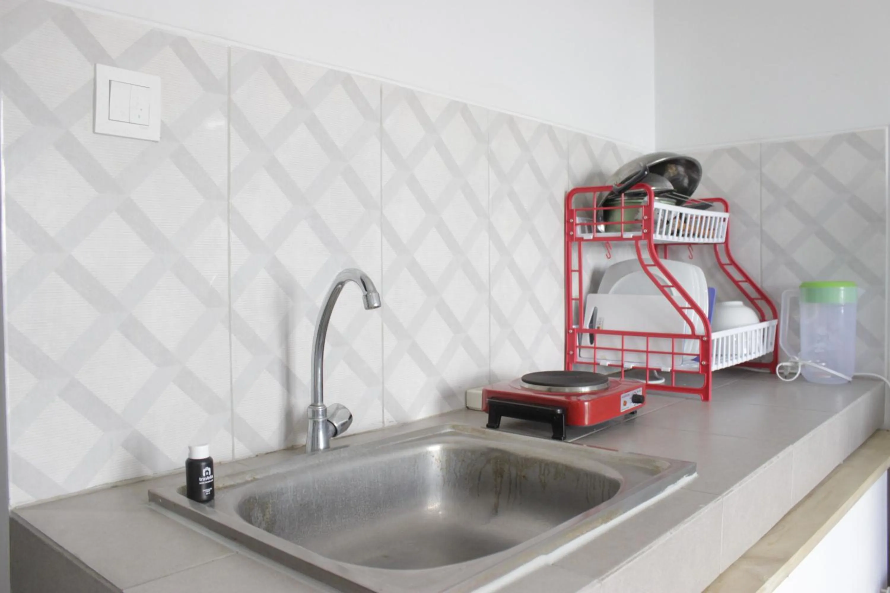 Kitchen or kitchenette in Comfy 2BR Apartment at Mekarwangi Square Cibaduyut By Travelio