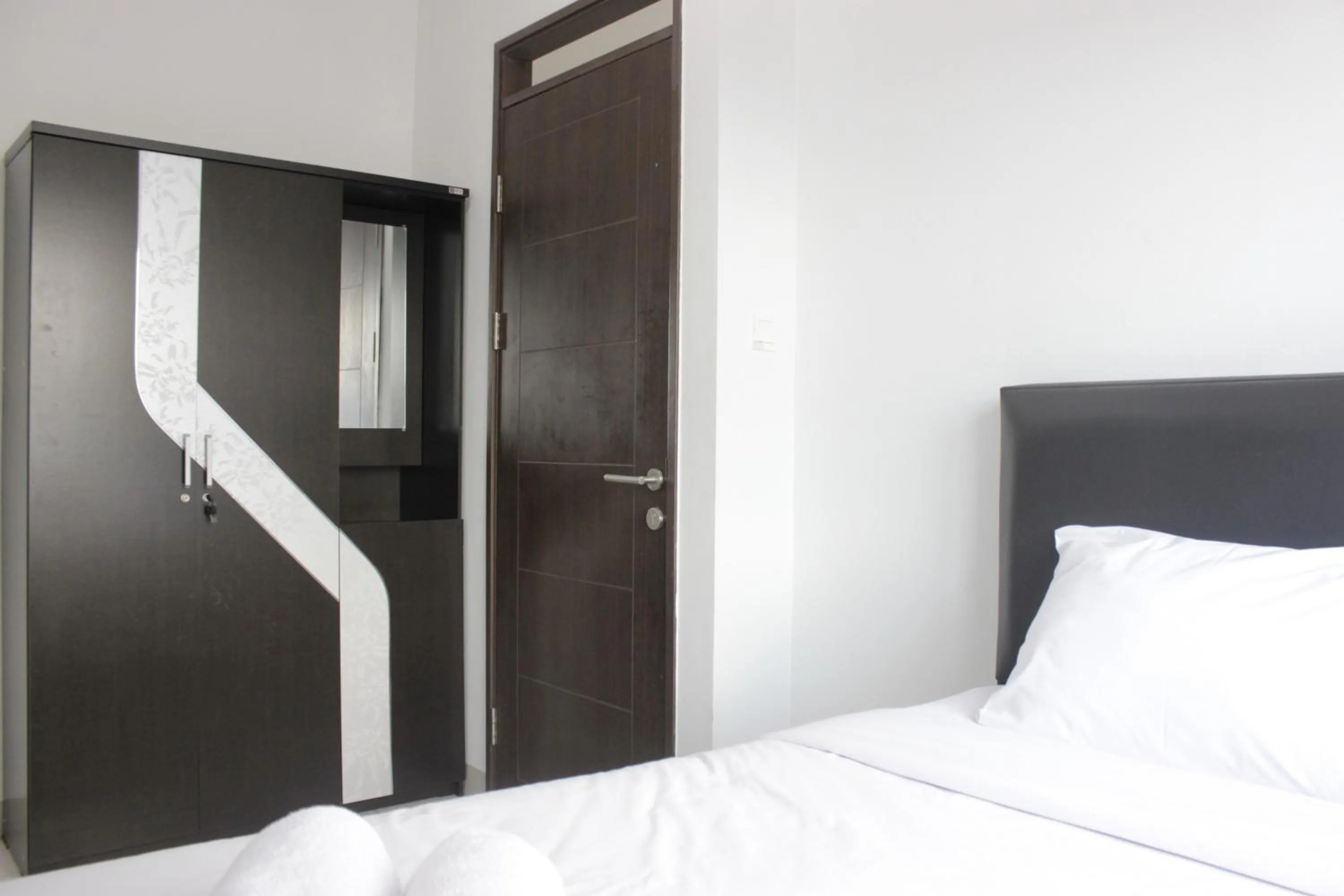 Bed in Comfy 2BR Apartment at Mekarwangi Square Cibaduyut By Travelio