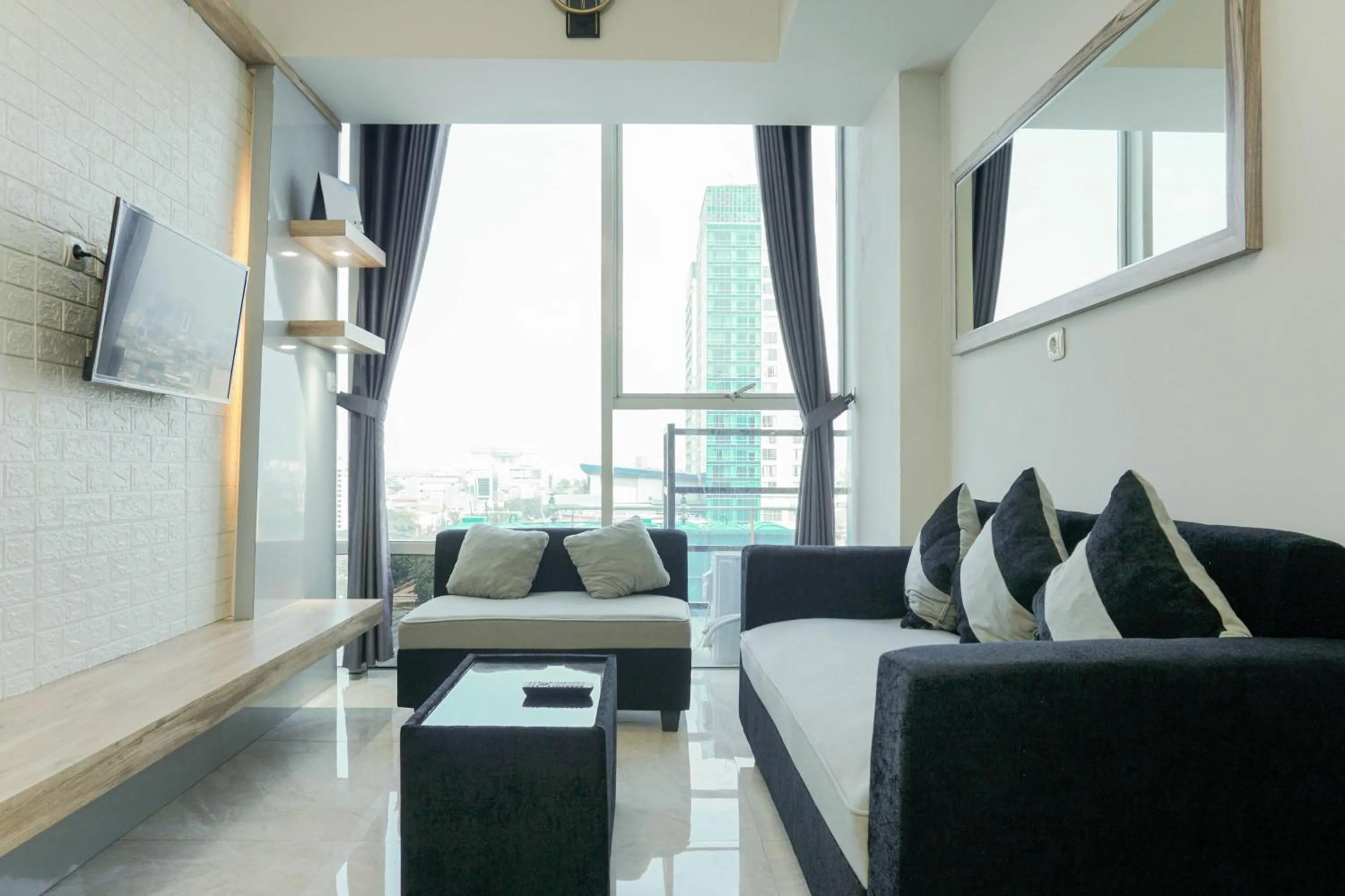 Living room in Fully Furnished with Comfortable Design 2BR Harco Mangga Besar Apartment By Travelio