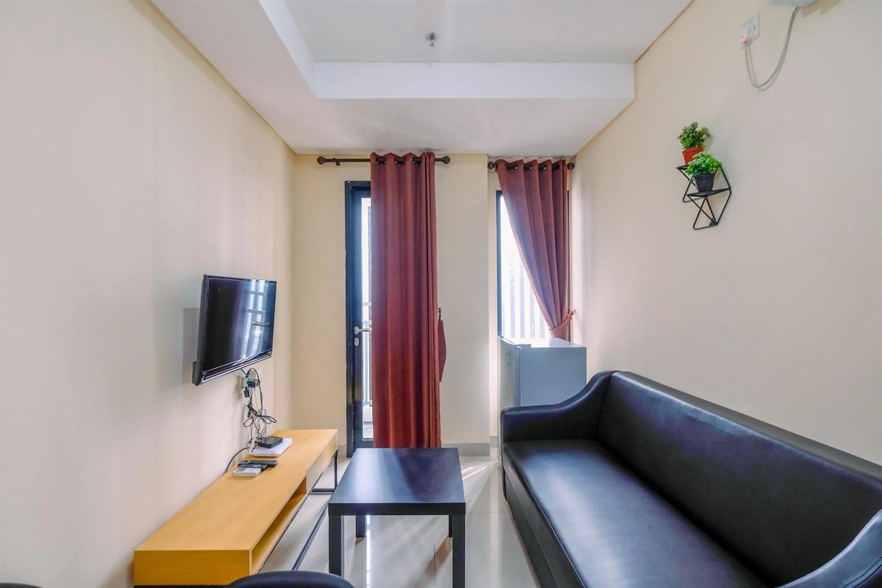 Living room in 2BR Best Rate Kebayoran Icon Apartment near Gandaria City By Travelio