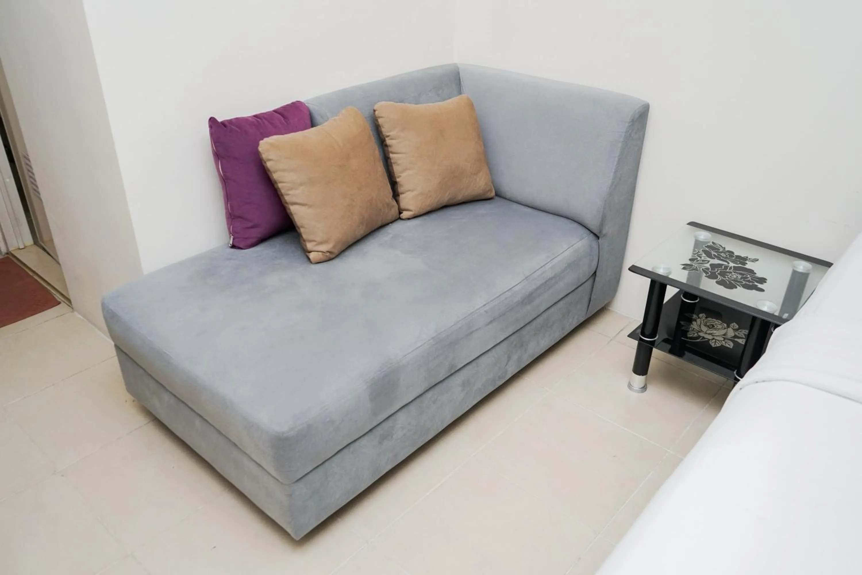 Seating area in Homey and Comfact Studio at Medina Apartment By Travelio