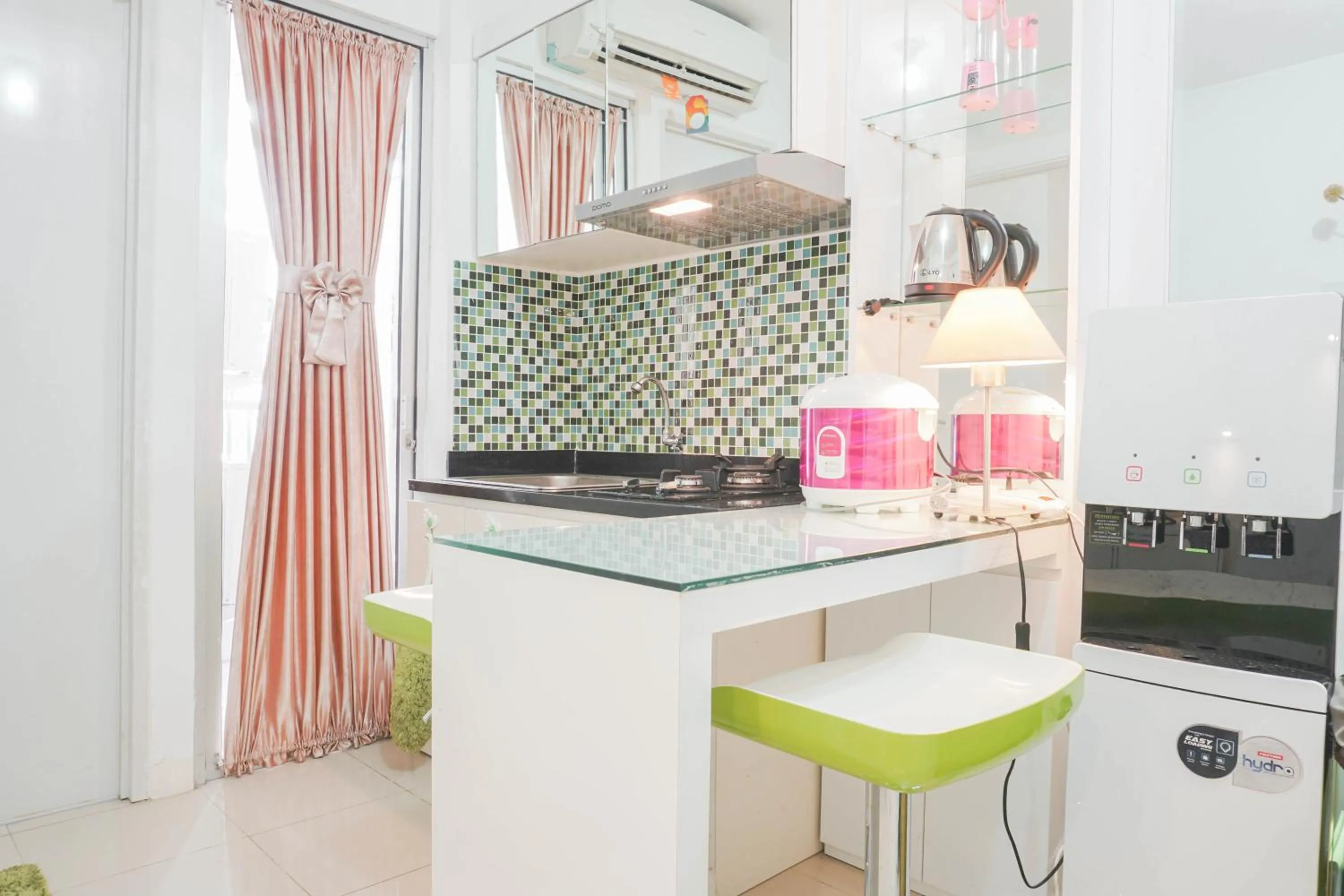 minibar in Elegant 2BR at Bassura City Apartment By Travelio