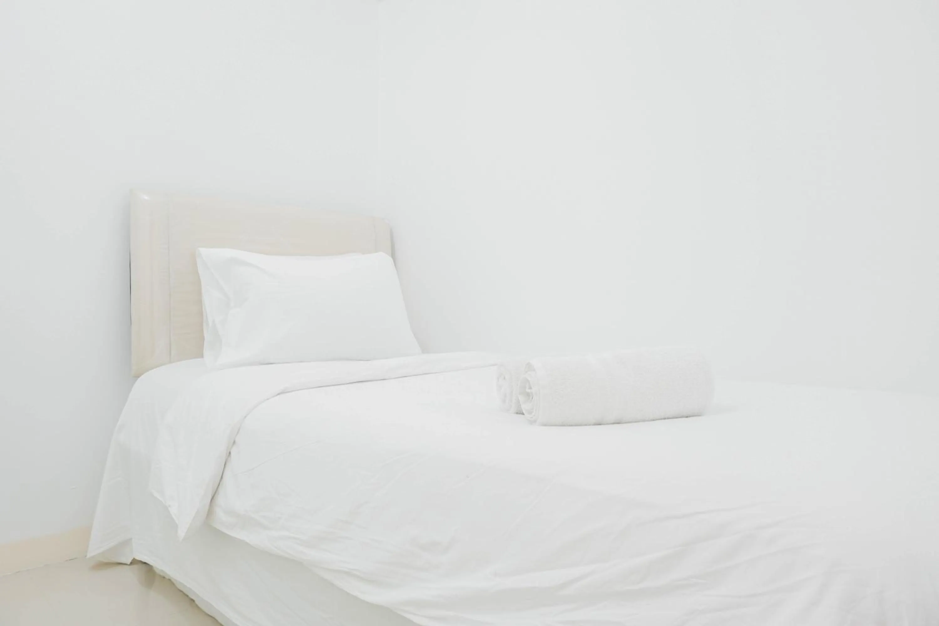 Bed in Elegant 2BR at Bassura City Apartment By Travelio