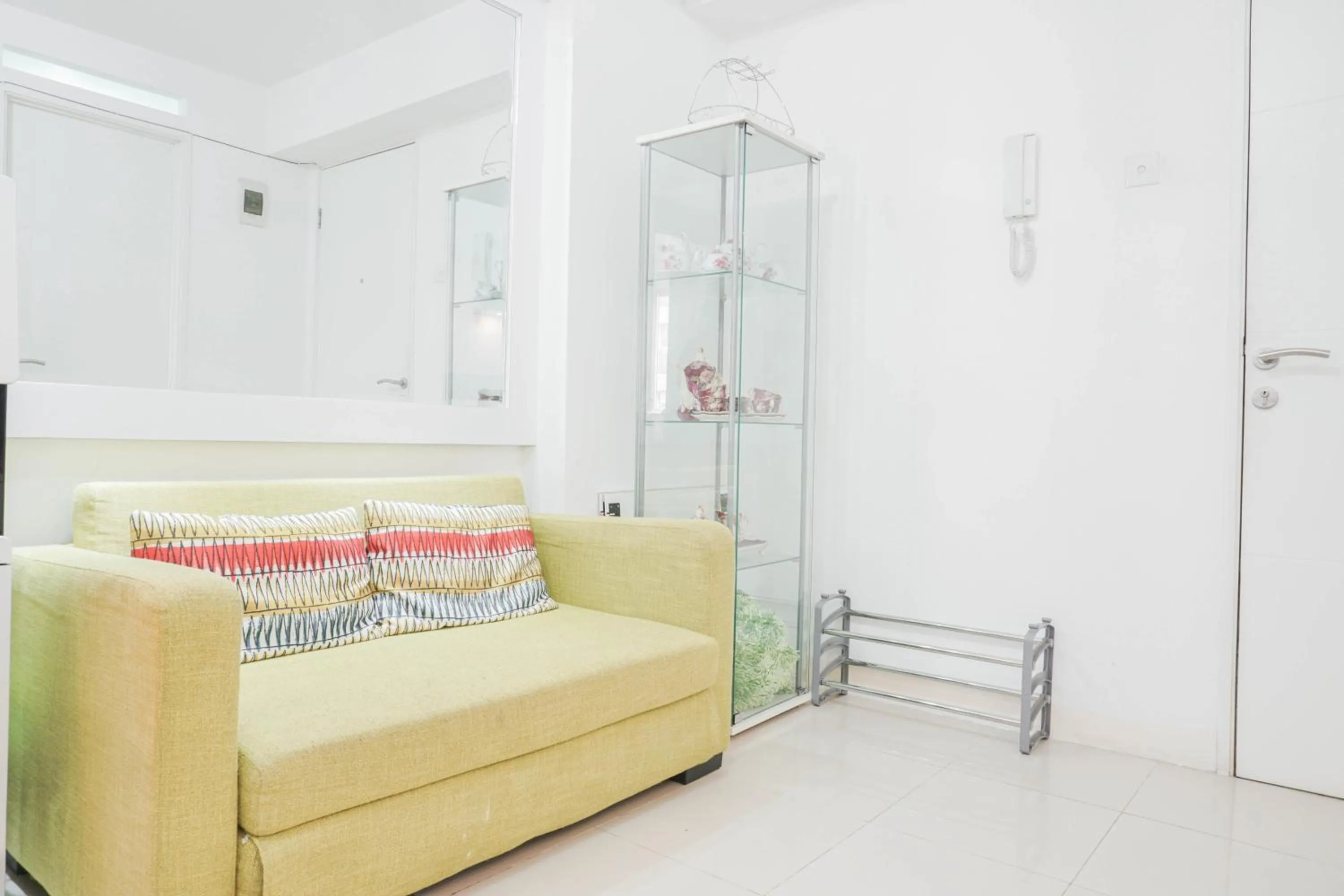 Living room in Elegant 2BR at Bassura City Apartment By Travelio