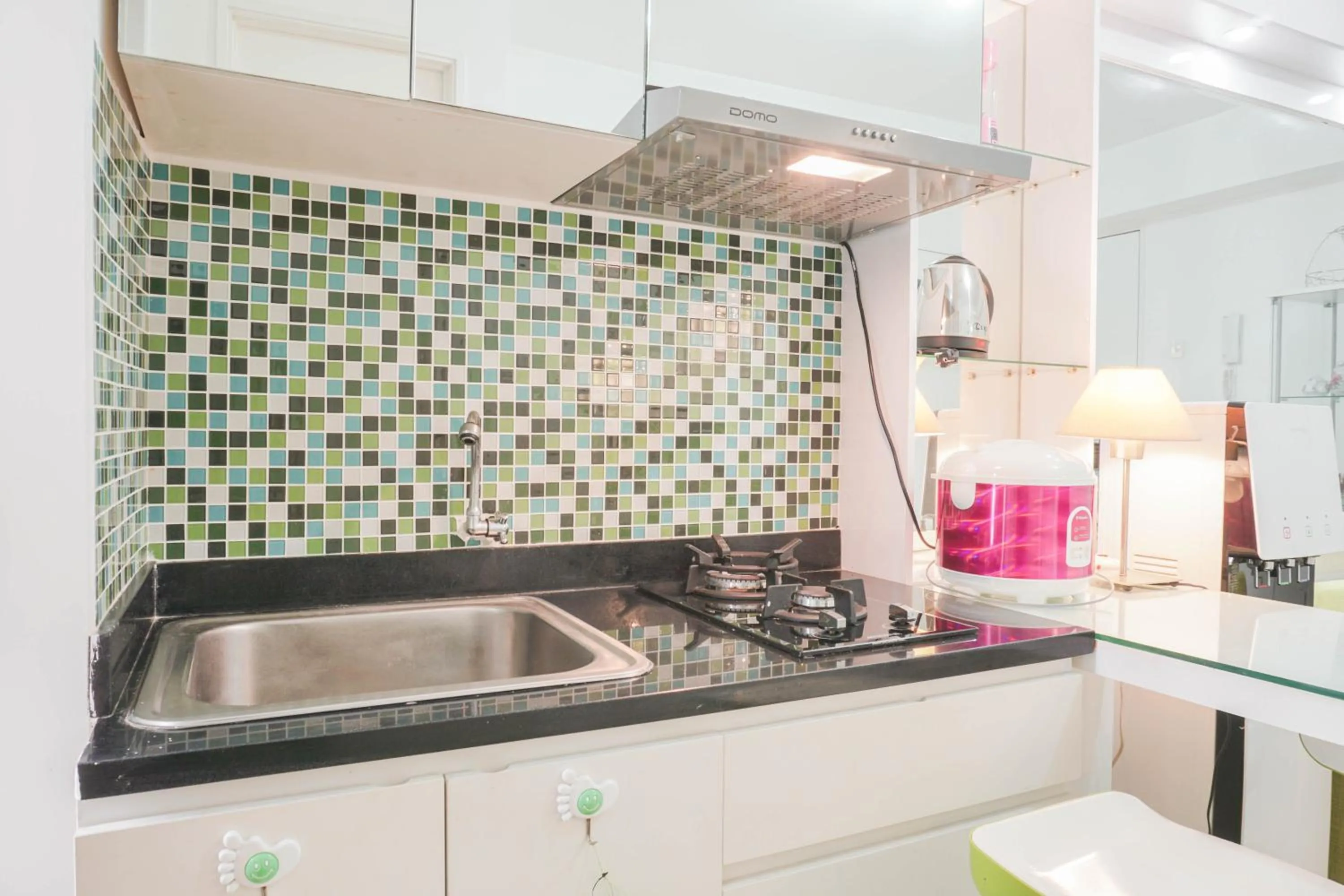 Kitchen or kitchenette in Elegant 2BR at Bassura City Apartment By Travelio