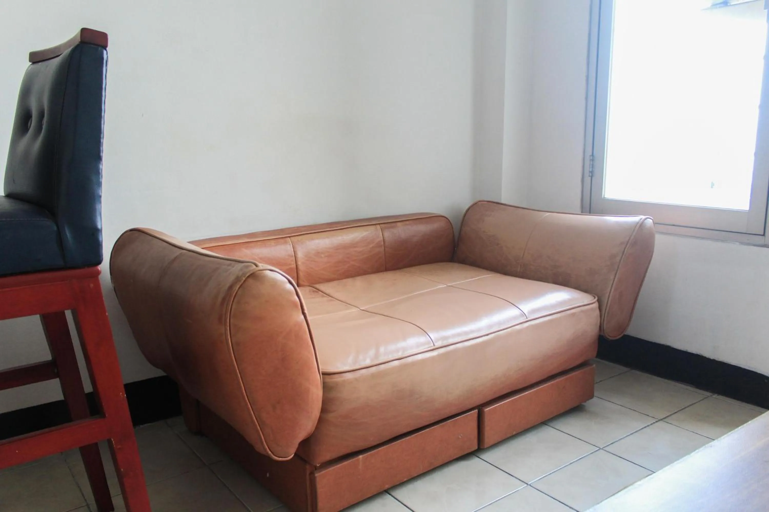 Living room in Best Price 1BR with Extra Room at Menara Latumenten Apartment Grogol By Travelio